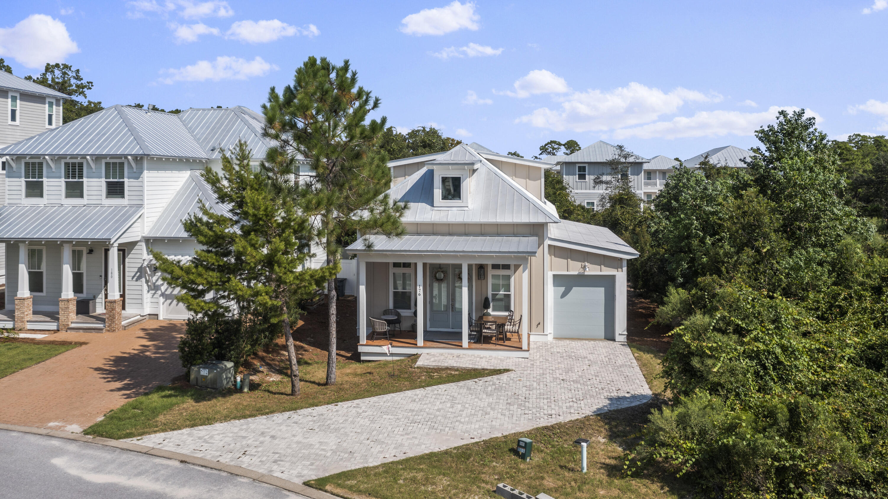 Don't miss this amazing cottage style home in the sought after community of Grande Pointe at Inlet Beach. Grande Pointe is located minutes away from Hwy 30a and Rosemary Beach and boarders Lake Powell, which is the largest coastal dune lake in North America, Camp Helen State Park. With the home being offered fully furnished there is nothing left for you to do! When you enter the home you'll notice the hardwood flooring that flows throughout the entire home and open floor-plan. Just past the beautiful kitchen featuring granite countertops and a gas range, you'll find the primary suite, 1/2 bathroom, and the laundry room. The primary suite is extremely spacious and the primary bathroom boasts a beautiful walk-in tiled shower, dual vanities topped with granite counters, and an oversized tub.