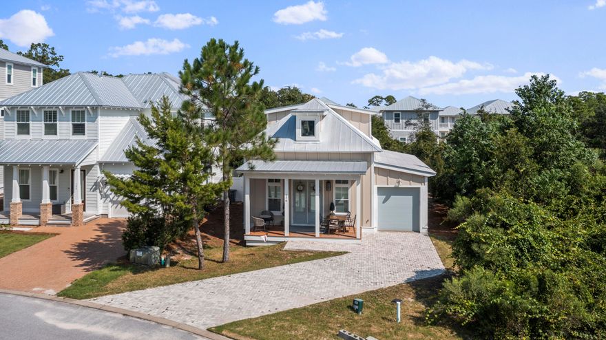 Don't miss this amazing cottage style home in the sought after community of Grande Pointe at Inlet Beach. Grande Pointe is located minutes away from Hwy 30a and Rosemary Beach and boarders Lake Powell, which is the largest coastal dune lake in North America, Camp Helen State Park. With the home being offered fully furnished there is nothing left for you to do! When you enter the home you'll notice the hardwood flooring that flows throughout the entire home and open floor-plan. Just past the beautiful kitchen featuring granite countertops and a gas range, you'll find the primary suite, 1/2 bathroom, and the laundry room. The primary suite is extremely spacious and the primary bathroom boasts a beautiful walk-in tiled shower, dual vanities topped with granite counters, and an oversized tub.