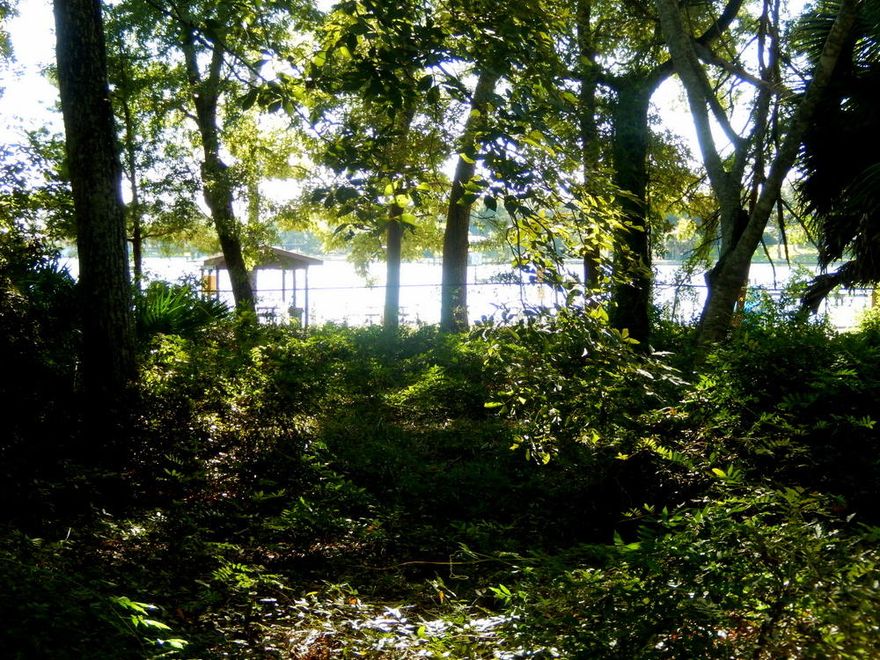 FIXER-UPPER WITH GREAT BAY VIEWS! Own in Poquito Bayou for $199,000 & have the opportunity to remodel this home's bathrooms,kitchen & floors to YOUR taste. Great bones & fantastic water views set the stage for success. Offering a spacious great rm w/fireplace,formal & casual dining areas, large master w/split floor plan, large utility & workshop area,2 car garage, and spacious sun room, this home is ready & waiting for a creative new owner. Although the home sits on a large lot approximately .39 acres, the adjacent .3 acre lot is available for an add'l $99,000. Backing up to beautiful Longwood park w/a free boat ramp on the Bay, a picnic & day on the water is just a short walk away. Take advantage of this opportunity to purchase one of the LOWEST priced homes in this neighborhood today!