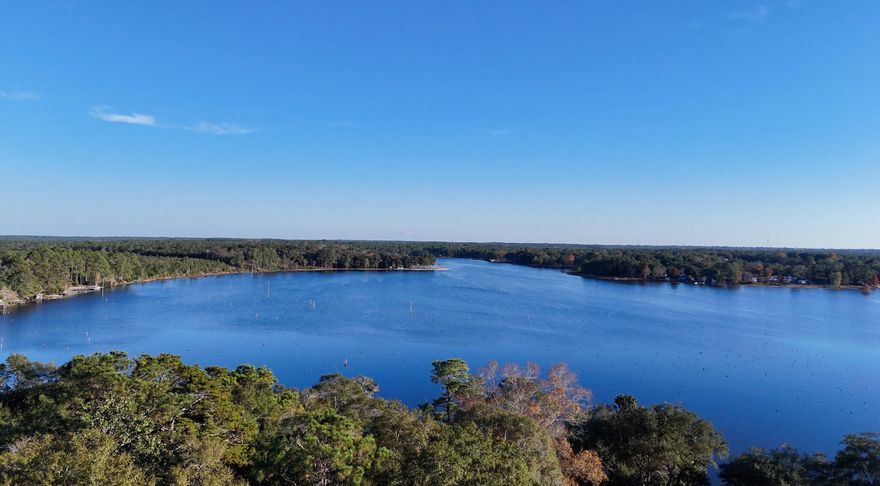 Welcome home to your custom craftsman escape on Lake Juniper, where peaceful living and unforgettable sunsets welcome you every day. This charming home features 1,000+ sq ft, an open, inviting layout, a large walk-in shower, and a true laundry room--all designed for comfort and ease.Set on two and a half acres, the property offers a long driveway framed by gorgeous trees, a relaxing front yard and covered patio overlooking the lake, and a convenient covered carport. Whether you're sipping coffee at sunrise or winding down as the sun sets over the water, this home delivers a serene lakefront lifestyle.This is your chance to own a private lakefront sanctuary with room to expand.