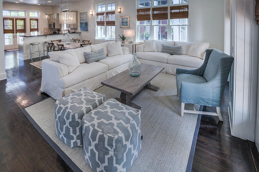 Tranquility. Tucked beside one of Rosemary Beach's beautiful courtyard parks is where you find this haven to call your home. The perfect family vacation getaway or rental property, this 2400 sf, 3 bedroom/bath home is thoughtfully designed to bring the outdoors in. Generously sized windows overlook the park and porches and allow the natural light to accent the lovely dark hardwood floors throughout. A beautiful chevron-patterned Carrera marble fireplace catches your eye as you enter. Then, take note of the tastefully decorated living and dining rooms, elegant yet comfortable. There is an openness to the first floor which is wonderful for keeping family and friends close. In the kitchen you find all you need to feel at home. Generous black granite countertops, stainless steel appliances,