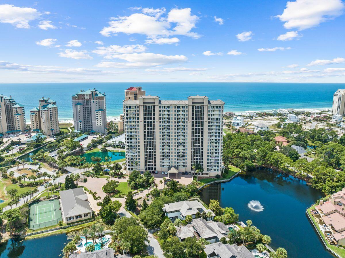 This spacious three-bedroom, three-bath condo is located in the prestigious One Beach Club Drive community within the extensive Sandestin Golf and Beach Resort in Miramar Beach. Well priced to allow for any desired updates by new owners, this upscale condo welcomes you into a generous dining area and bright sitting room. Outstanding views of the shimmering Gulf of Mexico can be enjoyed from almost every nook and cranny of this open floor plan. Bathed in abundant natural light, the wood flooring and neutral decor create an enviable place to relax and entertain. The open kitchen has ample workspace with stylish black appliances and granite countertops. Tuck into a hearty breakfast at the breakfast bar before heading out to the golf course or beach. Return home for celebratory drinks on the extensive balcony while reveling in the panoramic views. All three bedrooms boast full baths and unparalleled gulf views, ensuring guests receive the best possible experience. The master bath is particularly spacious with a deep whirlpool tub and separate walk-in shower.
Residents and guests can relax by the beautiful pool, play tennis and pickleball on the private court and enjoy socializing in the entertainment and media rooms where game nights and movies may be hosted. The state-of-the-art fitness room is equipped for the ultimate workout. The condo comes with assigned underground parking and electric car-charging facilities are available. There's also an underground parking space for a golf cart, available separately. A secure storage space is included on the garage level. 502 One Beach Club Drive has hurricane shutters stored on property for your convenience if ever needed. A membership at the private, newly updated Sandestin Beach Club is included with ownership at the cost of a transfer fee. A recently added dog run area is available for your pampered pup. Rentals are not allowed in this gated community.
Sandestin's many activity offerings include four golf courses, a tennis center, Baytowne Marina, water sports, a fitness center, hiking and biking for all to enjoy. Shopping, dining, entertainment and local events at Grand Boulevard, The Market Shops and The Village of Baytowne Wharf are just a golf cart ride away.