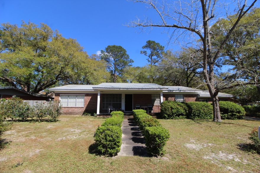 LOOKING FOR A HOME WITH A LARGE LOT IN THE HEART OF FORT WALTON BEACH? Step into the foyer to find gabled wall cut-outs that open into the formal living room and dining room. Light and bright kitchen with lots of cabinets and counter space, center island with sink and dishwasher and a 5 burner gas stove. Breakfast area overlooks the family room. Family room offers you a fireplace for those cool evenings and a door that leads out to the open patio area. Master bedroom has a private bath with a shower. Two additional bedrooms each have hardwood floors. One of the bedrooms has access to a large room that the seller used as another bedroom for guests and a sitting area with French doors leading out to the back patio. Large inside laundry room with a walk-in pantry. Backyard is fully