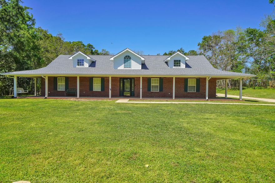 Gorgeous Brick Ranch on 2 acres with expansive covered front porch and BRAND NEW ROOF.  Home boasts 4 bedrooms plus an Office with Murphy Bed. Enter foyer to find open concept living-dining and kitchen with cathedral ceilings. Split bedroom floor plan with 3 bedrooms on one side and Master with en suite bath on the other. Large granite counter wraps around the kitchen featuring stainless appliances.  Wood flooring throughout.  Two doors flank the gas fireplace and lead to large 2 acre yard.  Trees line the back end of the property.  Handy Storage building and workshop with power. Side entry double garage leads to laundry room and then kitchen with large pantry. Home wired with camera system and high speed internet. Hybrid tankless/tank water heater. Country Living at it's Finest!