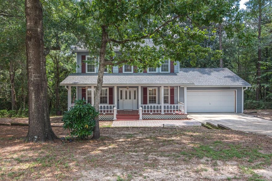 Nestled among the trees with the feel of a rustic cabin, you are home! This beautiful custom built home has a great view of the surrounding woods, and is settled on a half acre lot in North Crestview. Featuring original hardwood floors throughout the large, open living area and a spacious kitchen with stainless steel appliances. The bedrooms are located upstairs, and the master bedroom features a walk-in closet and large en-suite bathroom with double vanity. The back deck overlooks a green belt and is perfect for outdoor entertaining. Sit on your front porch swing in the evening and listen to the neighborhood birds. Schedule your appointment today!