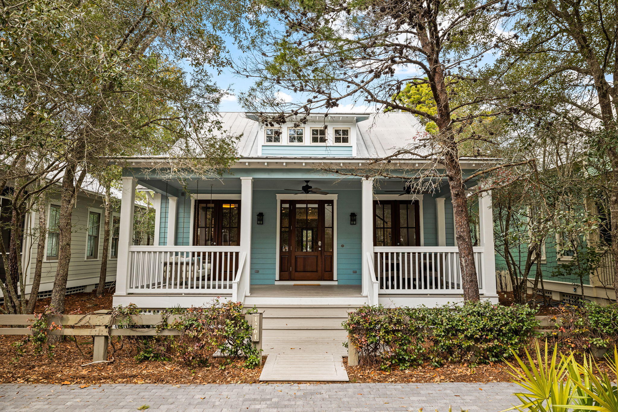 Welcome to 1261 Western Lake Drive--a quintessential Watercolor beach cottage located in the camp district and just one block from the popular Camp Watercolor. This home features a spacious front porch for classic Watercolor outdoor living that opens into the living and dining area where you will immediately note the gorgeous soaring ceilings. The dining area flows seamlessly into the kitchen and a hallway connects two first floor bedrooms and a screen porch & grilling area. The upstairs has two additional bedrooms, one with built in bunks--a perfect spot for kids to have their own space. From its prime positioning, shopping & dining within the Watercolor Town Center, tennis/pickle ball courts and the recently overhauled Beach Club are all a short walk or bike ride away.