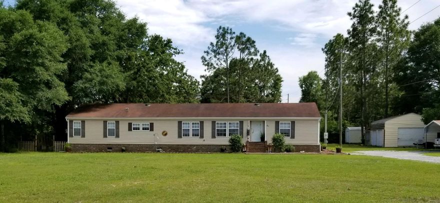 Nice 4 bedroom plus office home on .91 acres with many upgrades including brick skirting with brick stairs walk up to front door. Two living room areas and large open kitchen. There is enclosed shop perfect for tools and toys equipped with power. Large Florida room on the back of the home great for entertaining and extra space.