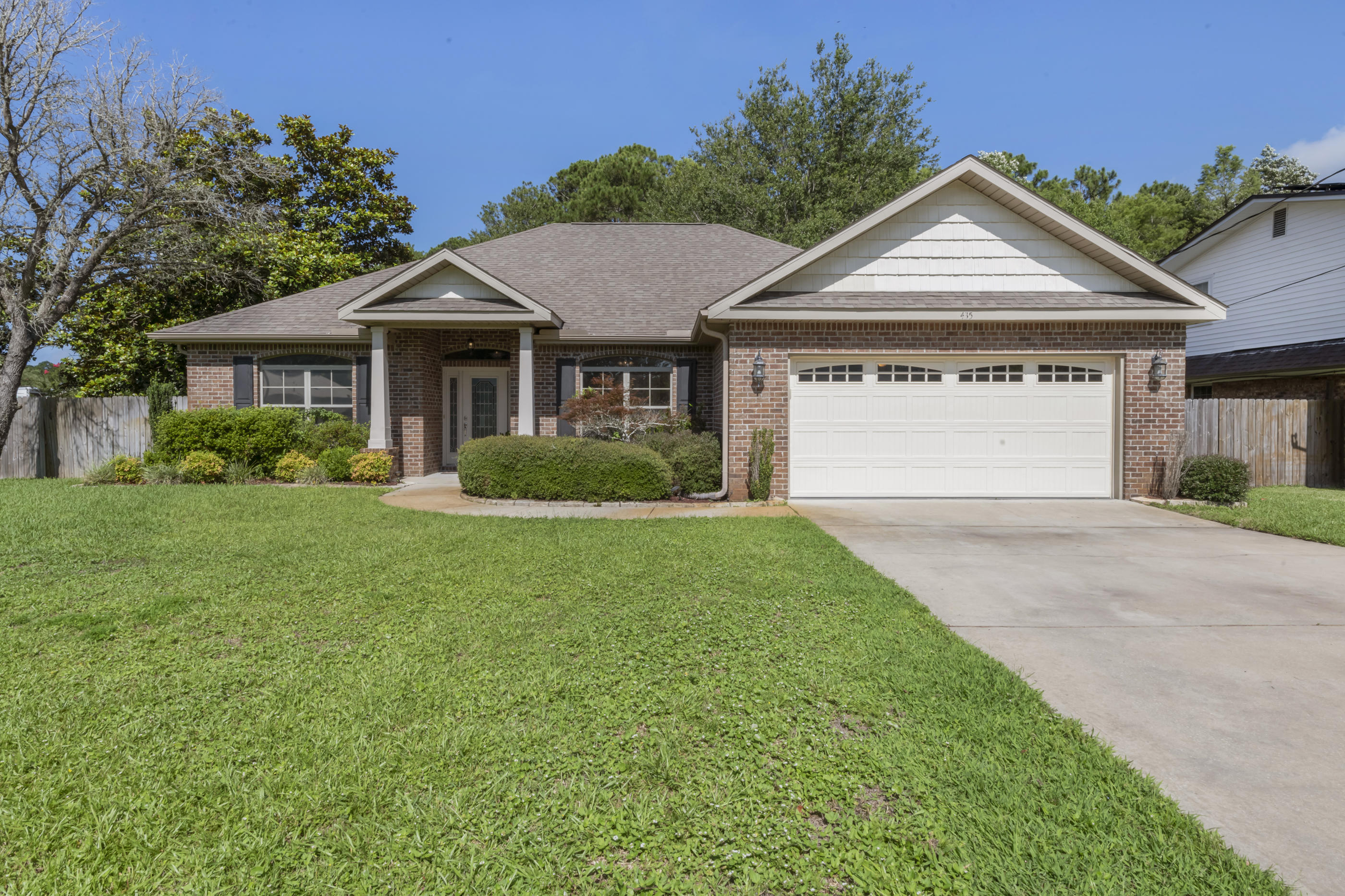All-brick contemporary single story home just 5 miles from Hurlburt Field, this 4-bedroom split, open floor plan enjoys a ''big feel'' with 10' ceilings in the foyer, great room and kitchen. So many extras include the beautiful glass front door with matching side lights, crown molding in the dining room, and the relaxing lanai in the backyard. Large master bedroom includes spacious walk-in closet, tray ceiling and bath enjoys cultured marble double vanity, garden tub & separate shower. Kitchen includes granite countertops, raised breakfast bar and large pantry. Yard is fully fenced w/front & backyard sprinkler system. Home is ready for a quick close so you can start enjoying your summer enjoying the beautiful Emerald Coast!