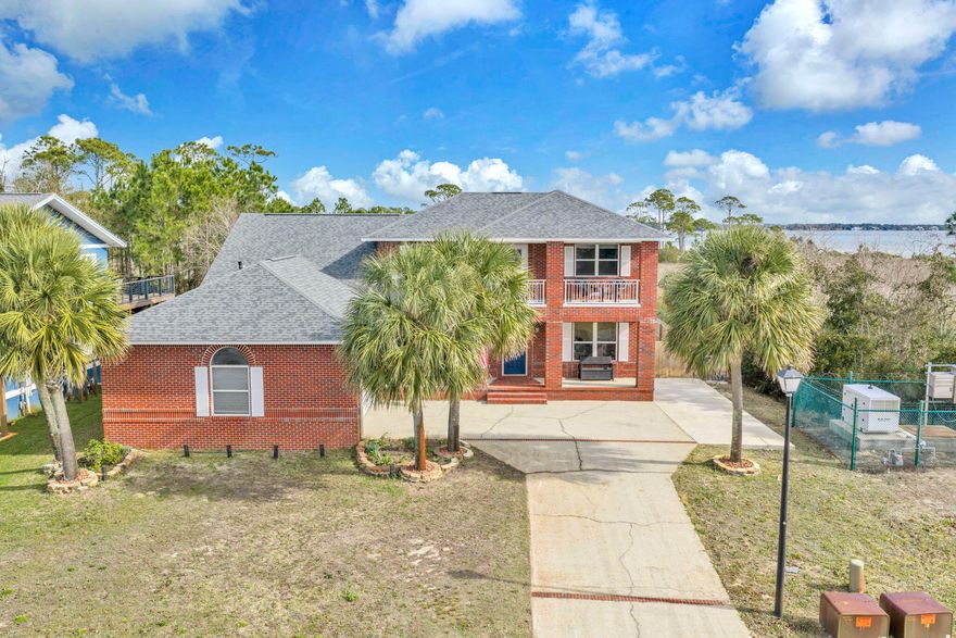 Gorgeous brick and pool home with 2858 sq ft, 4 bedroom and 3 full baths located in a waterfront community, Emerald Pointe! This home has views from many rooms of the beautiful Santa Rosa Sound! Watch sunsets from the front balcony and sunrises from your back patio! Private beach access in this community allows for fishing, paddle boarding, canoeing and boating! Relax on the upper balcony and watch sunsets and dolphins playing in the Intercoastal waterway! Enter the home into a foyer which opens to the great room, the dining room, and kitchen. The kitchen features stainless and black appliances to include a French door refrigerator, dishwasher, stove and oven and rangehood. Other features include custom cabinetry with crown, granite countertops, and brushed nickel hardware and faucet. The kitchen has water views of the sound. There are two raised bars that seats up to 7 guests and seating at the island. There is an open floor plan with the kitchen opening to the dining room and great room. The ceilings are vaulted in the eat in kitchen area and in the living room they are vaulted and double height. Ceilings in the bedrooms are 9 feet. The dining room has picturesque windows overlooking the pool and Sound! The living room has a gas fireplace with custom surround and mantel, built in entertainment center with crown. There are tile floors that have a wood grain look. The dining room is adjacent to the kitchen and has views of the sound and front yard. There is a guest bedroom on the first floor and a full guest bathroom. The laundry room is large and leads to the oversized two car garage. In addition the primary bedroom is on the first floor and is very large! There are views of the backyard, pool and intercoastal waterway! There are two walk in closets with custom closet systems and a very large primary bathroom. The bathroom has a spa tub, walk in shower, and two separate vanities. Lighting has been updated throughout the home. Upstairs there are two additional bedrooms and a Jack and Jill bathroom. The upstairs landing is large enough for a home office. The upstairs bathroom has is very long with double sinks and has raised panel doors and cultured countertops. The views from this home are unbelievable. Open the 2 inch vinyl blinds and there is the water! The exterior of the home is perfect for coastal living. The large, covered upper balcony features room for seating and provides views of the sound and sunsets! The back yard has an in ground pool with a liner. There is a firepit and built in planters for herbs or flowers. The community features deeded beach access and a private dock! This home provides privacy on two sides! There are unobstructed views of the sound from the back yard. The Roof (2021 yr) and HVACs have been replaced. Buyer to verify all dimensions and information.  