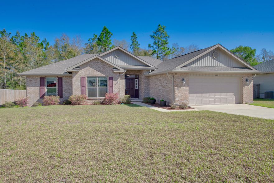 This home is better than brand new and is turn key ready.  As you enter the front door, you are welcomed by the spacious living room with raised ceilings which flows into the kitchen.  The kitchen features granite counter tops, a large breakfast bar, stainless appliances and a huge walk in pantry.  The master bedroom has trey ceilings and plenty of space for all your furniture.  The large master bathroom features a separate tub and walk in shower, dual vanities, and his and her walk in closets.  The split bedroom floor plan allows for privacy.  The additional 3 bedrooms are all ample sized.  Imagine sitting outside in your back porch enjoying a cup of coffee while watching nature, and protected from insects.   The home has gutters, and is protected from termites by the Sentricon  system.