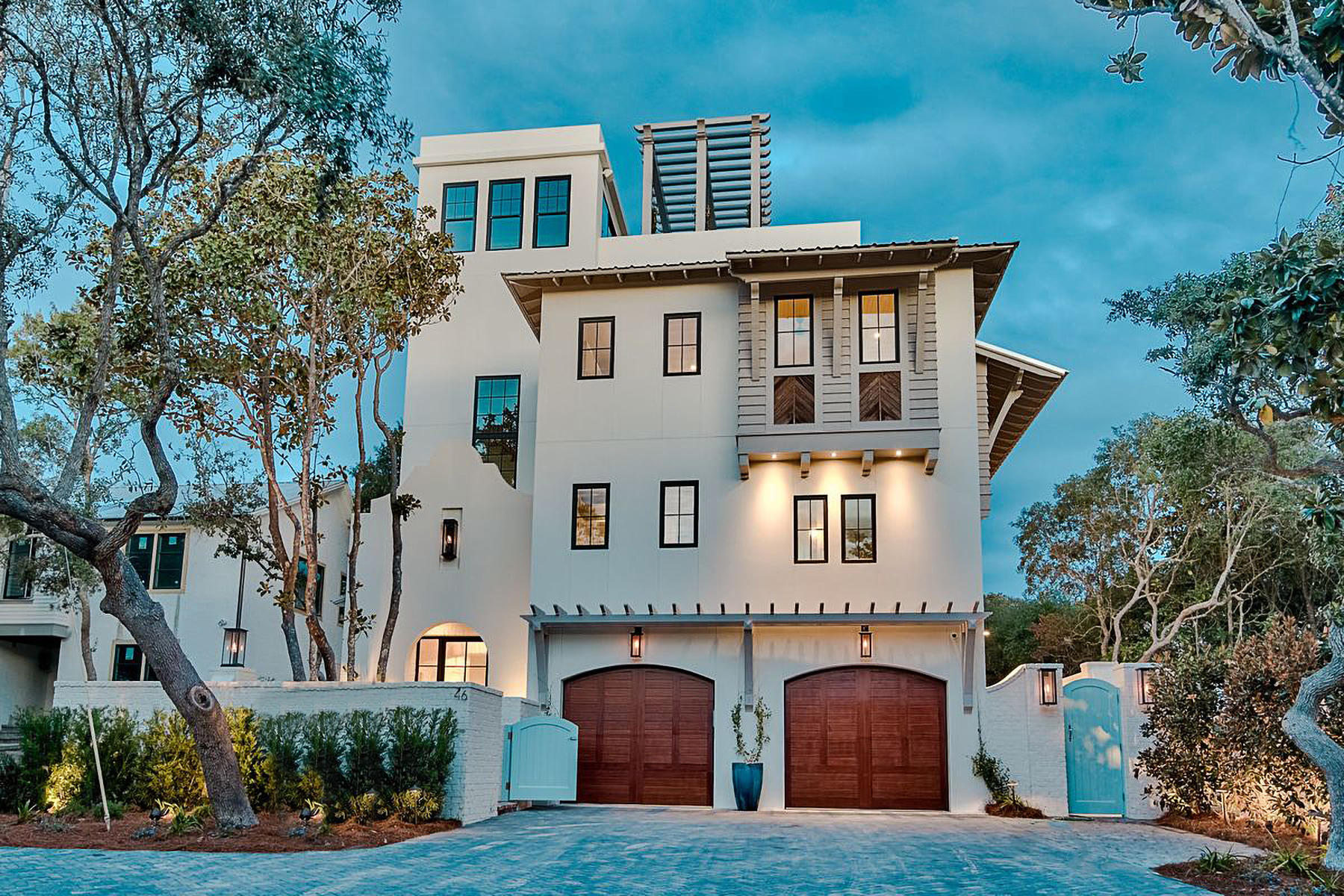 Stylish coastal contemporary design juxtaposed artful sophisticated decor define this highly curated family retreat primely located on Azalea Street; only one block from the beach; in Old Seagrove Beach, along 30A. Designed for legacy living, this seven bedroom home is heavily amenitized and well appointed offering an open floor plan design with multiple living spaces on each level and optimal accessibility from the hydraulic elevator allowing easy access to all four levels. The formal entryway is a beautiful walled courtyard complete with sprawling native vegetation and ambient gas lanterns flanking a steel front door which flows seamlessly into a spacious vestibule highlighted by reclaimed wood ceilings and painted brick accents.