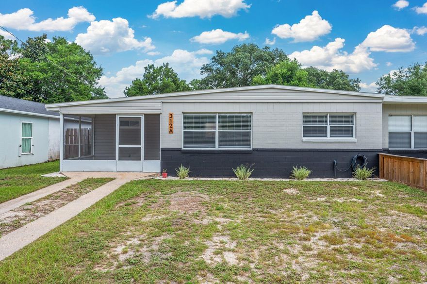 This charming, single-story, all-brick duplex offers modern updates and classic appeal. Featuring 3 bedrooms and 1 fully renovated bathroom, the home has been freshly updated with new carpet, crisp white paint, and a ceiling fan for comfort. The bright, refreshed kitchen boasts stone countertops, stainless steel appliances, and a clean, modern look. The bathroom includes a ceramic bathtub with a tiled surround for a sleek finish. Enjoy quiet mornings on the screened-in front patio or entertain guests on the rear paver patio overlooking a very large, fully fenced backyard complete with a small storage shed. A spacious laundry room adds convenience and functionality to this move-in-ready home.