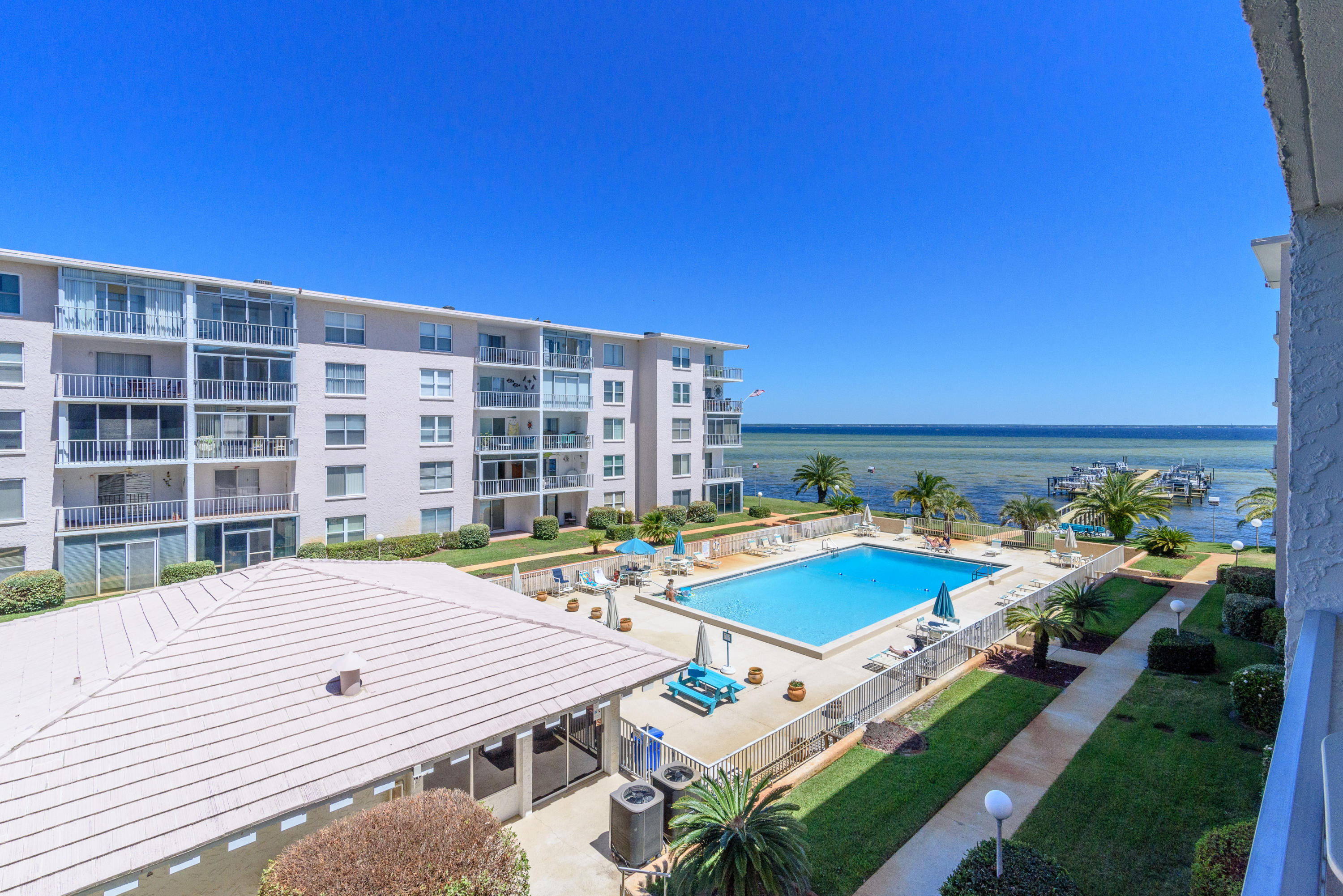 Live on the Bay, in the heart of Destin! Immaculate, completely renovated condo boasts Incredible designer kitchen with KitchenCraft cabinetry installed by Marquis Cabinets, granite counters and all Bosch stainless appliances. The Kitchen includes a wine rack, Minka-Aire Coco designer fans, and hand blown designer pendant lights at the breakfast bar. Travertine flooring is installed throughout, with bathrooms completely tiled and renovated. Crown molding throughout for a nice finishing touch.Watch dolphins in the breathtaking views of the Choctawahatchee Bay from the living room, Master bedroom, balcony and large heated pool area. Sip coffee or wine on the newly renovated docks, or drop a line and do some fishing.