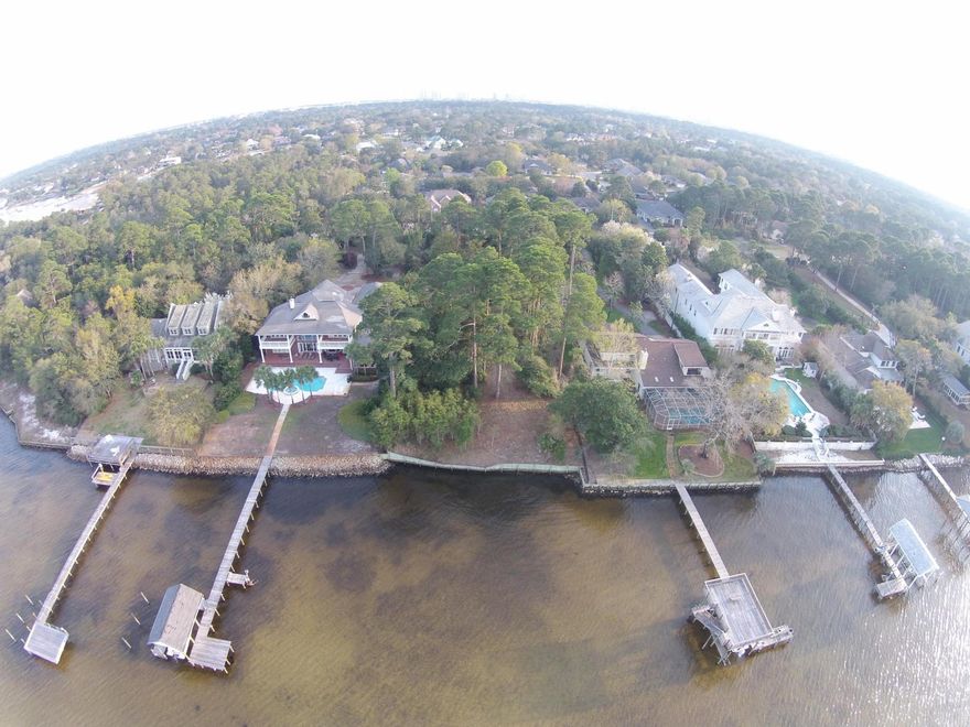 Build your dream home with Million-dollar views from this estate lot. 0.85 acres with 100 feet of private Bayfront. Large established trees. Existing seawall. Recent survey is in Documents