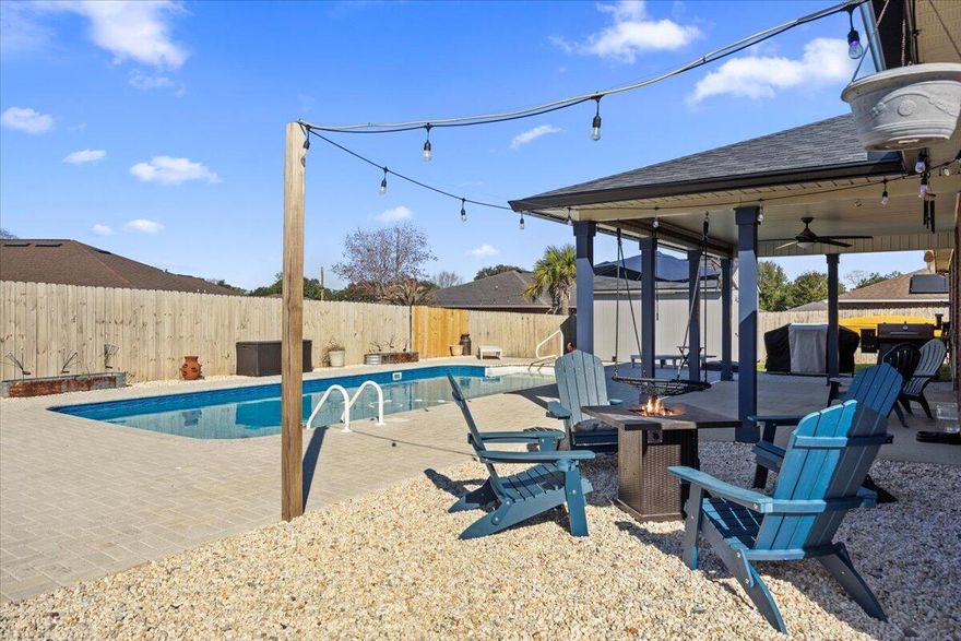 *Pool Home with a 2024 ROOF/HVAC/GUTTERS!* Home sits on a spacious corner lot in Navarre's La Mesa at Hidden Creek. You're going to love this pool home featuring 4 bedrooms, 3 bathrooms, with 2 separate flex rooms (currently used as a formal dining and office). Through the front door past curated landscaping, you'll find the two flex rooms on either side with a great sized living room just beyond featuring a floor-to-ceiling entertainment/fireplace with open concept and vaulted ceiling. The kitchen has a hop up bar and is open to eat in kitchen space that overlooks the backyard. The split floor plan allows for owner's suite privacy with a great sized room and an en suite which has TWO walk in closets, double vanities, water closet, separate garden tub and shower. The other 3 bedrooms are great sized with 2 sharing a bathroom in the hall, and the 3rd using the bath right off the living room. The interior laundry room leads to the 2-car garage which contains a 12,000 BTU mini split air conditioner/heater for year-round climate control. Home was equipped with an upgraded 5-ton HVAC in 2024 to help with those hot Summer days! Enjoy the outdoors or entertain with the large, covered patio with a ceiling fan. Directly off the covered patio is a 14'x30'x7' in-ground saltwater pool installed in 2023. There is a completely customized paver deck around the entire pool. To the left is an area with led lights ready for nights around a fire pit. To the right is a paver addition to be used for seating, grilling, or entertaining. The back yard is fully fenced in back yard complete with a large 12'x16' outdoor storage building with solar lights! The whole home has Govee permanent outdoor lighting in the soffit for year-round personalization! There is also a security system in place that the owner can customize to their needs. Home has electronic, easy-access locks on front and back doors for ease of entry for family, guests, or when you lose your keys. Home sits on a corner lot in a cul-de-sac with sidewalks throughout neighborhood. Experience the best of Florida living close to Navarre's beautiful Emerald Coast beaches! Roof, HVAC, gutters, and permanent lighting are all 2024!