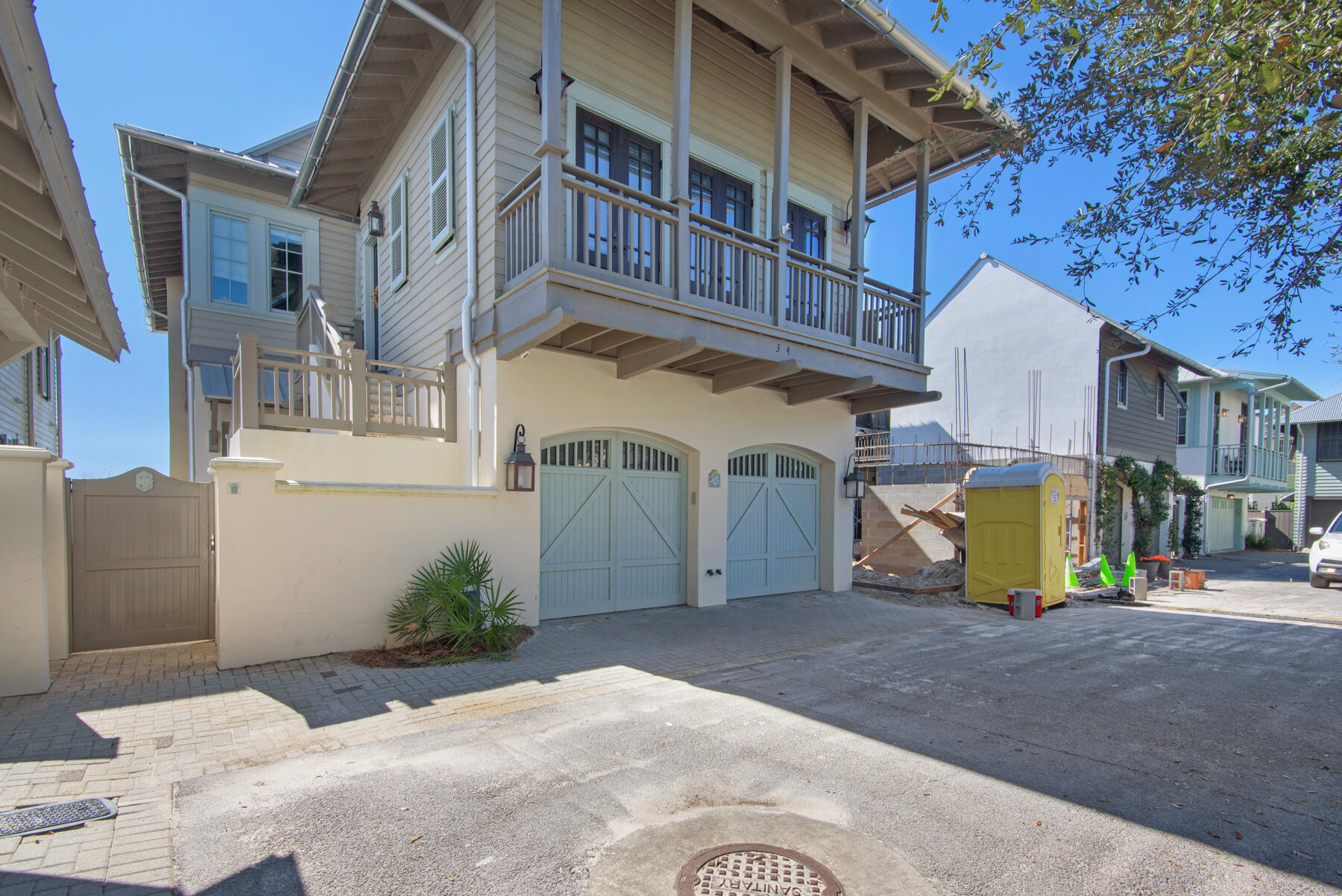 Prominently placed on the Gulf in Rosemary Beach, this essential escape on Atwoods Court boasts a complete renovation, exquisite finishes, and architectural beauty. As you enter the residence, you notice a quiet & tucked away courtyard in between the carriage & main house. Upon entering the main house, you are greeted by a lovely cubby space & a delightfully placed staircase. The first level offers two bedrooms. The first bedroom you reach is a tasteful bunk room with a walk in closet & en suite bathroom. Throughout are lovely finishes such as grey-stained hardwood floors, a modern tile, & fresh decor. Across the hallway is the first floor master bedroom with towering ceilings, & an extra sitting area overlooking Bahama shutters outside the window. The master bathroom is marvelously