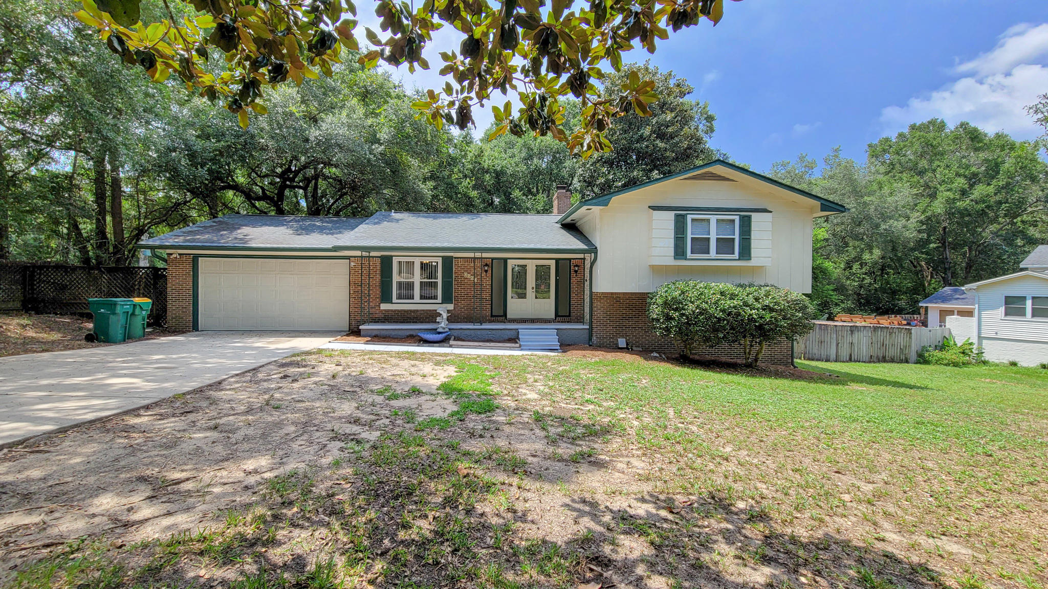 Spacious and comfortable 4 bedroom split level home w/ LARGE BACKYARD and deck, perfect for entertaining! The main level is home to the common areas, living and dining space with stone fireplace, kitchen with breakfast nook and bay window facing the nicely landscaped front yard, and a two car garage w/ storage. Upstairs, you'll find two nice size guest bedrooms with plenty of closet space, full guest bathroom, and master bedroom w/ vanity, large walk-in closet, and private water closet. Downstairs, use this level as a guest suite! Spacious living space with unique fireplace and brick accent wall, utility room (washer & dryer included), large guest bedroom and full bathroom w/ walk-in shower. Enjoy peaceful evenings on your back deck, as the property backs up to private wooded area!