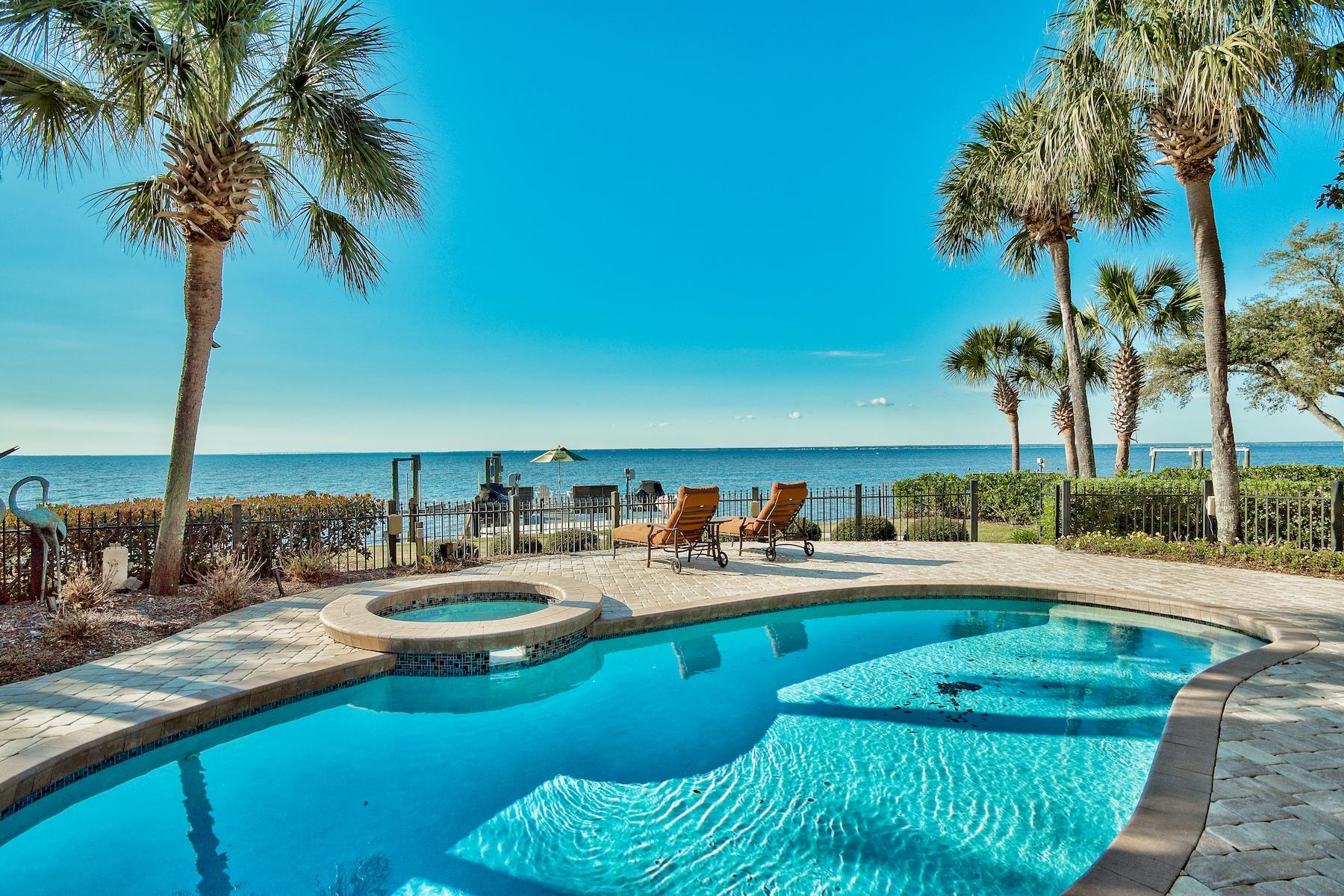 Bayfront Living with Pool, Dock and Wine Room. This 3 bedroom/4 bath 3,573 sq.ft. home in Burnt Pine is for those who desire waterfront living, stunning sunsets and a room for everything. Set on a peaceful wooded lot with pool and private dock, it offers more than a luxury home it's a lifestyle.This bayfront home offers views all throughout the home. There are two nice size living areas offering options for an office, den, exercise area, etc. The breakfast room off the kitchen is the perfect way to start your day enjoying the breathe taking views of the morning sun. End your day gathering with family and friends around the well designed bar area equipped with refrigerator drawers and ice machine.