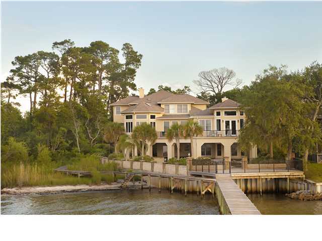 Gorgeous Panoramic views from this Bay Front Estate located in Gulf Breeze, FL. Spacious porches with an abundant amount of outdoor living make this home perfect for entertaining family and friends. Enjoy beautiful sunsets from every floor or relax out on your own private dock complete with boast lift and second floor sun deck. Equipped with a whole house generator. The inside of this home was been completely renovated with every upgrade you could imagine. The Gourmet kitchen has a Wolf Duel fuel range, custom cabinets w/ self closing drawers, subzero refrigerator and freezer drawers, island w/built in microwave, granite countertops and mexican tile floors. The family room off the kitchen includes: Built in TV, Gas fireplace, and surround sound. The Oversized Master bedroom has