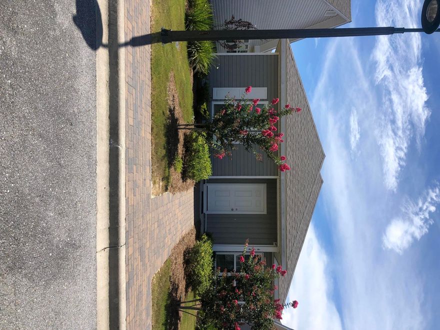 Florida cottage style home in Schooners Landing. Almost new home has wood laminate floors, open floor plan with split bedrooms. Open Kitchen, dIning and great room concept. Rear entry garage.