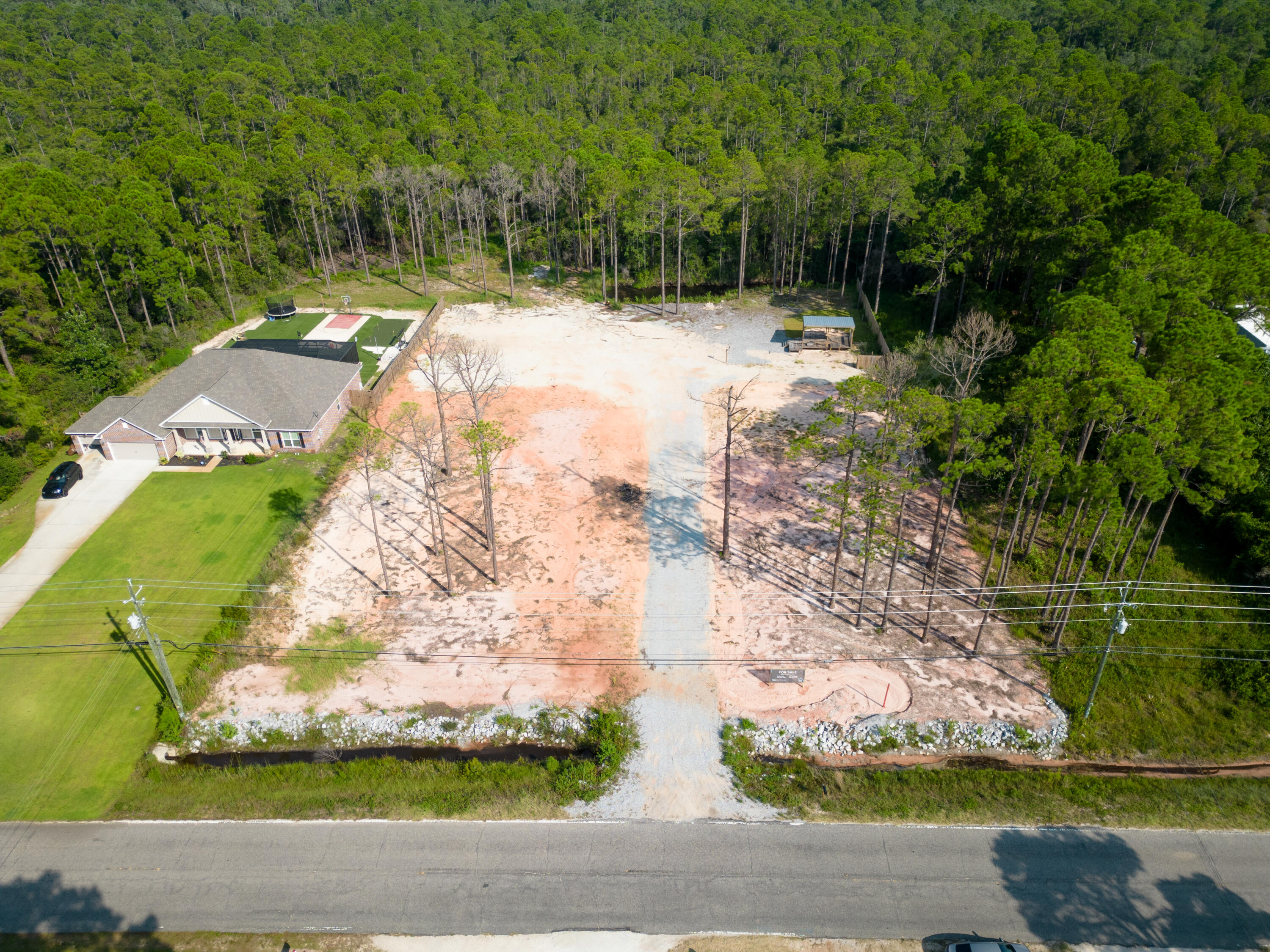 Build Your Dream Home on This Prime Land!Welcome to 6489 E Bay Blvd, Gulf Breeze, FL 32563, where your dreams of a custom-built home can come to life! This 1.38-acre parcel of land presents a rare opportunity to create your own oasis.Already cleared, leveled, and surveyed, this exceptional property offers the perfect canvas to craft your ideal residence. Originally two lots thoughtfully combined, you have the flexibility to keep it as one expansive estate or explore the potential of dividing it and building two homes.Water and power are readily available on the property. Additionally, the lot is equipped with 50amp hookup ready to accommodate your recreational vehicle.Whether you're looking to design your forever home or seeking an investment opportunity, this land offers  boundless potential.