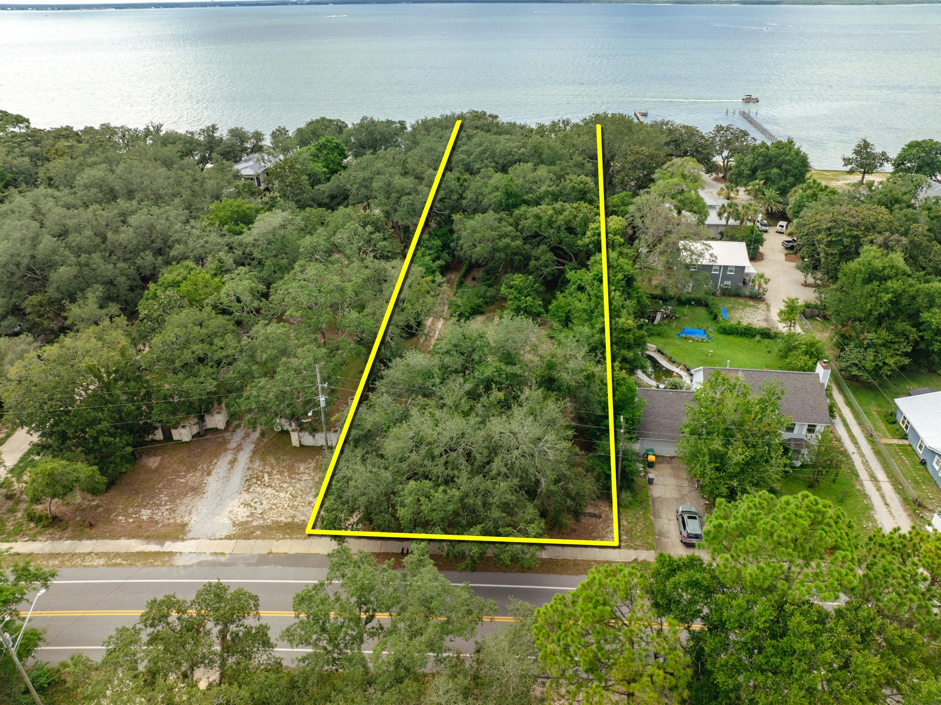 **NEW LISTING** NO HOA! Extraordinary 1+ acre parcel expanding 90' along the scenic shores of the Choctawhatchee Bay in Destin, Florida! This quintessential old Florida property contains an historic cottage constructed in 1929, while the indigenous landscape provides a fabulous canopy of legacy trees gracing the nostalgic homestead. This rare waterfront parcel, showcasing a breathtaking view corridor across the beautiful bay waters, would accommodate a phenomenal custom family compound. Please inquire to coordinate a private showing. Please do not trespass on the subject property without being accompanied by the listing agent(s).