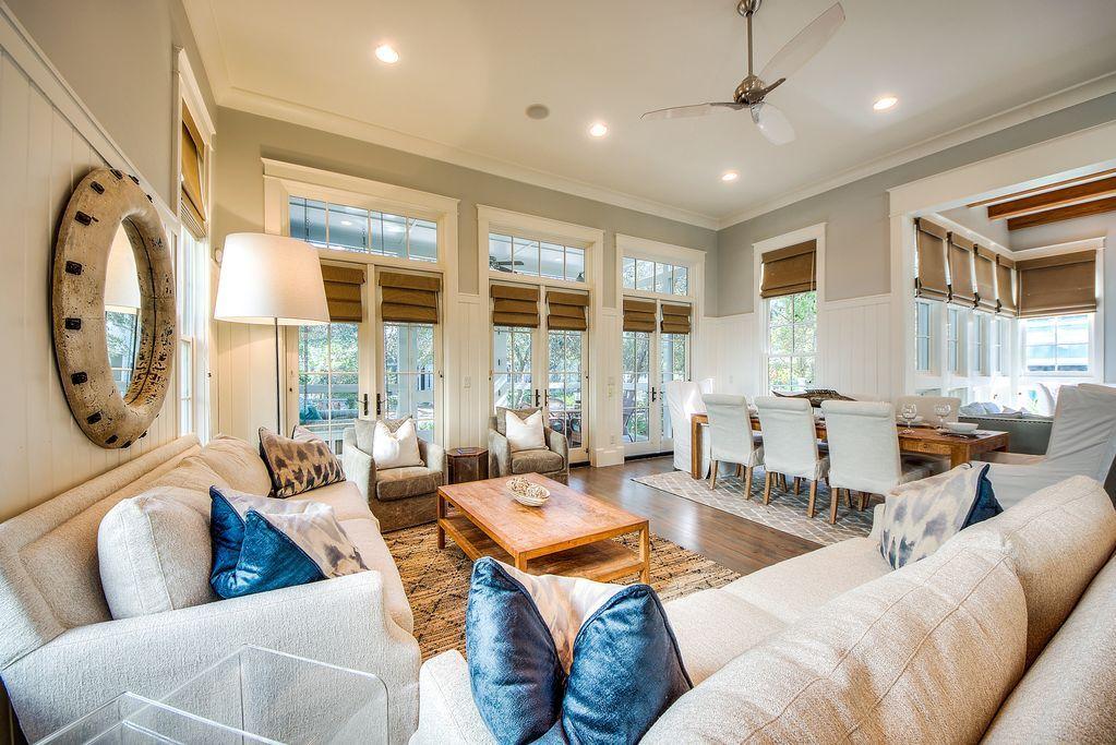 Welcome to this beautiful corner lot home located on the highly sought after Bluejack Street in Phase 3 of Watercolor. Sold completely furnished and turn key, each aspect of this home has been thoughtfully designed to provide an incredible living experience for your family and guests. From the complete built in Sonos Audio System with multiple zones throughout the home, to the vaulting 12 foot ceilings and incredible floor to ceiling windows in the living room and throughout the home as well as the full size porches with lower being screened in, this home resonates a large impression for a price that doesn't break the bank. Stepping into 91 Bluejack Street you are greeted with two sitting areas accompanied by a large flat screen television hoisted over a gas fireplace. A dining area that-