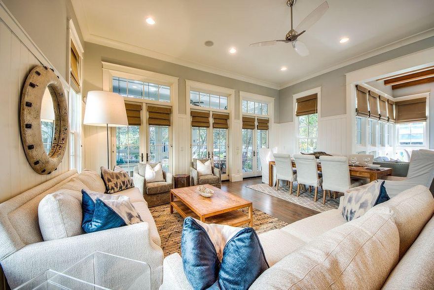 Welcome to this beautiful corner lot home located on the highly sought after Bluejack Street in Phase 3 of Watercolor. Sold completely furnished and turn key, each aspect of this home has been thoughtfully designed to provide an incredible living experience for your family and guests. From the complete built in Sonos Audio System with multiple zones throughout the home, to the vaulting 12 foot ceilings and incredible floor to ceiling windows in the living room and throughout the home as well as the full size porches with lower being screened in, this home resonates a large impression for a price that doesn't break the bank. Stepping into 91 Bluejack Street you are greeted with two sitting areas accompanied by a large flat screen television hoisted over a gas fireplace. A dining area that-