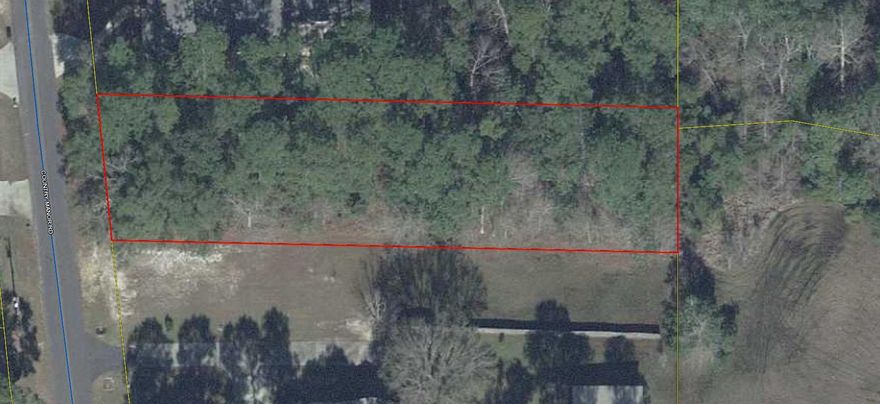 Beautiful wooded building lot on  paved road.  Property is located in the county, yet you feel you are in the city....This is a restricted unrecorded subdivision with beautiful homes.