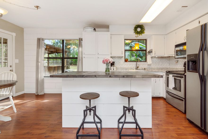 Chip and Joanna would be proud! Super cute 3 bd/1 ba home with a beautiful modern farmhouse look. Dont' let the age fool you - many upgrades throughout and brand new windows. Inviting front porch w/ plenty of room for your swing and rocking chairs. Light and bright interior complete w/ shiplap, white cabinetry and an open floor plan. Laminate wood flooring and adorable bathroom. Nice level lot and fenced in backyard w/ bar outback for entertaining your guests. Shed to convey ''as is'' and given no value. THIS HOME IS A MUST SEE!!!