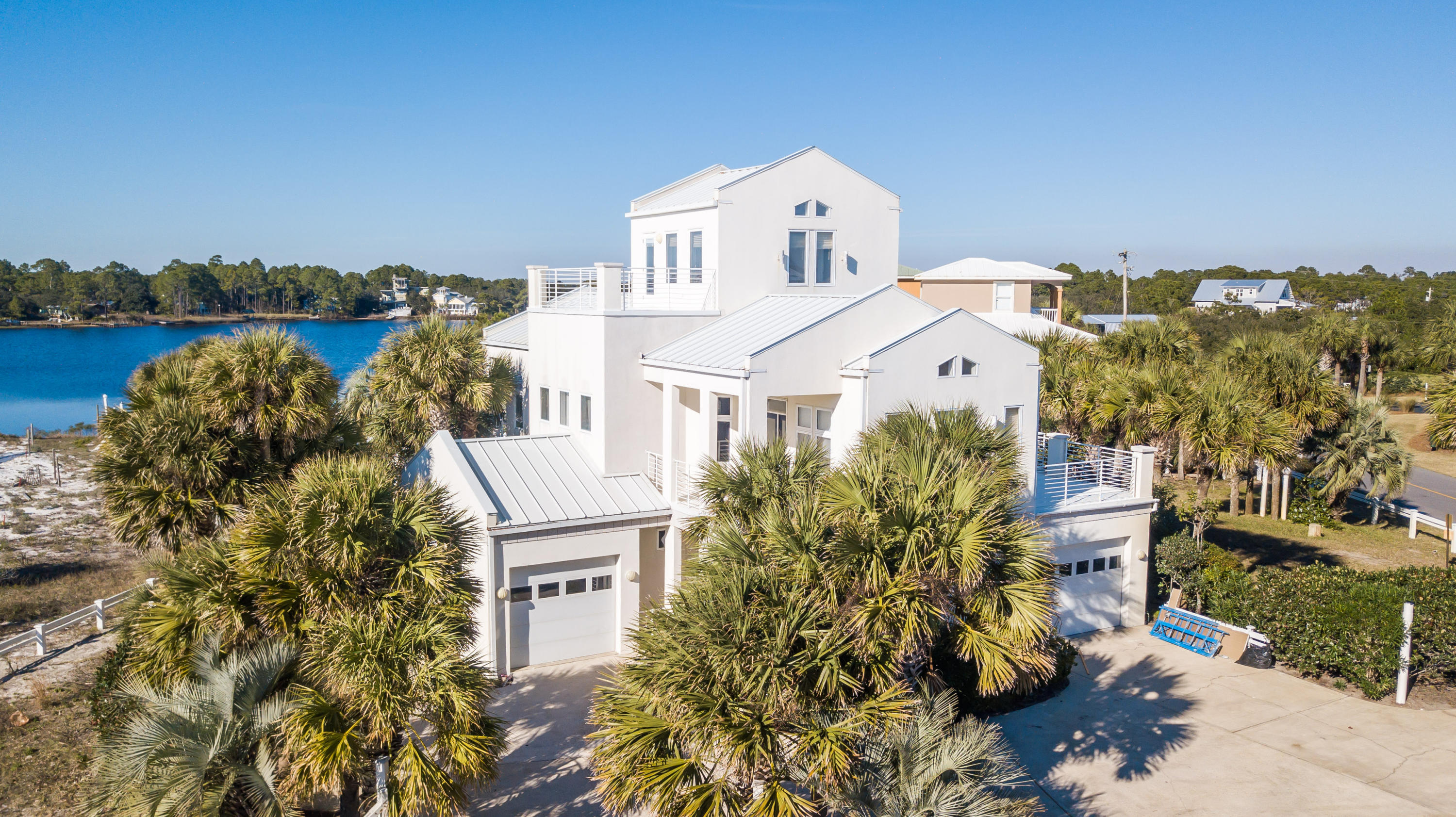 Stunning lake front property on Eastern Lake offering sweeping views of the Gulf of Mexico. Contemporary design along with astonishing architecture exemplify this incredible property. Located in Seagrove Beach, this estate offers outstanding access to enjoy all 30A offers including the sugar white sands, emerald waters, world-class fishing, first-rate dining and luxury shopping. Beach access can be found within steps of the home. This waterfront property features a private dock; private pool; separate guest quarters with kitchen; large lot; 2 private garages; vaulted ceilings, exquisite fixtures and designer finishes. The home boasts a large open concept great room featuring a gourmet chef's kitchen and large living area. The exceptional floor plan offers 4 bedrooms, 4 1/2 bathrooms