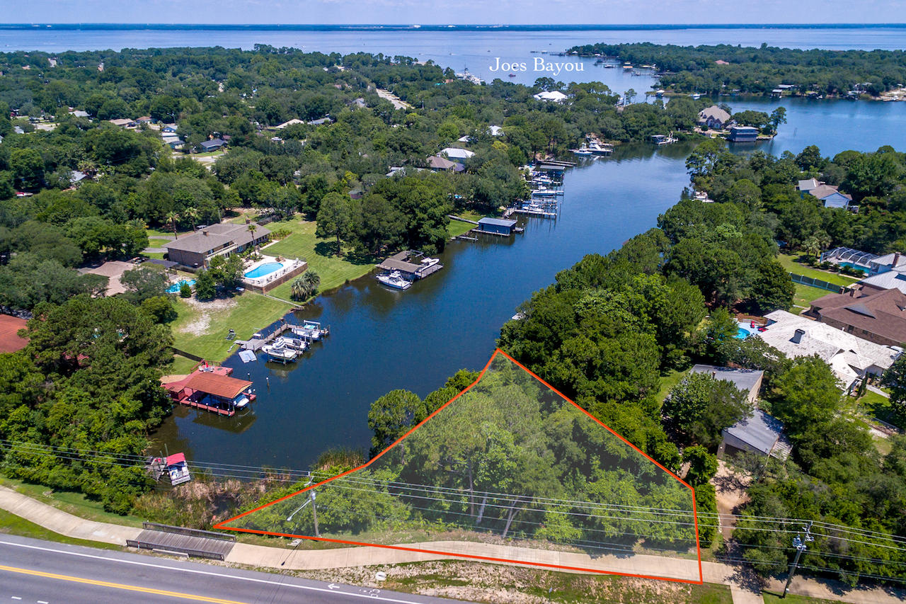 GORGEOUS waterfront lot with 179 front feet of deepwater access to the Gulf of Mexico! The beautiful cleared lot is located on Choctawhatchee Bay/Joe's Bayou and within one mile to the sugar white beaches of the Emerald Coast. Build your dream home here and experience the Destin lifestyle with boating, shopping, world class restaurants, top rated schools, and toes in the sand. Within 2 miles to the entertainment center of the Destin Harbor. New wide sidewalks have been installed fronting this lot. Across the street is a gorgeous duck/goose pond with optional feeding. Make all this yours today!