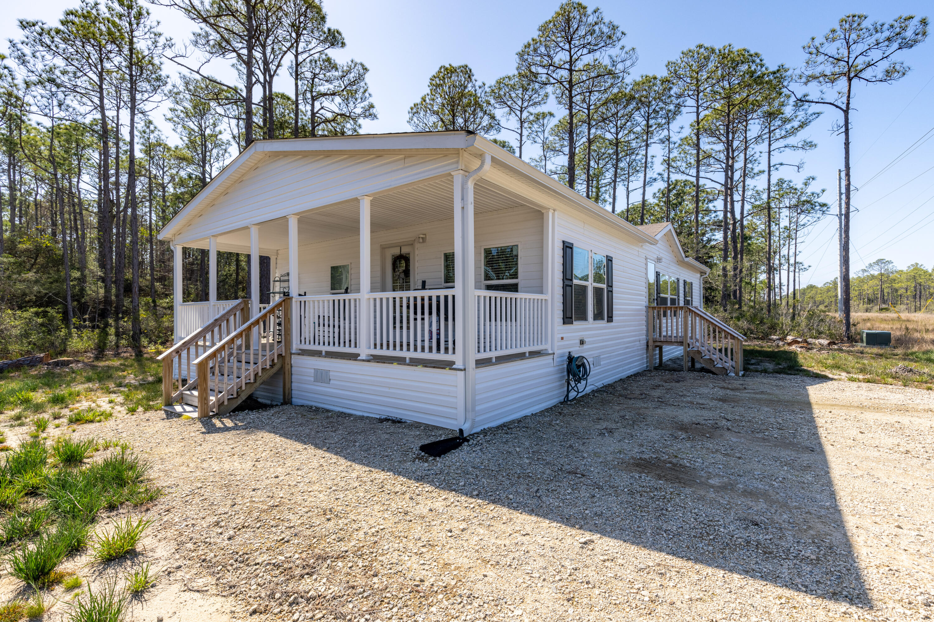 This inviting single family, three-bedroom home is situated on a private road with no HOA just 1.2 miles away from 30A! Upon entering this 2020 built manufactured home, you'll find high end look finishes from floor to ceiling. The modern primary bathroom and kitchen as well as the stylish finishings throughout provide the ideal blank slate for any design aesthetic. The home also boasts a large front deck ideal for grilling or entertaining, new storage shed, and a crushed gravel driveway with ample parking;. But the ultimate luxury of this home is it's convenient access to shopping, dining, and 30A's best beaches while offering the secluded feeling of rural living surrounded by Northwest Florida's natural beauty and wildlife. Virtual tour in photos is for floor plan reference only.