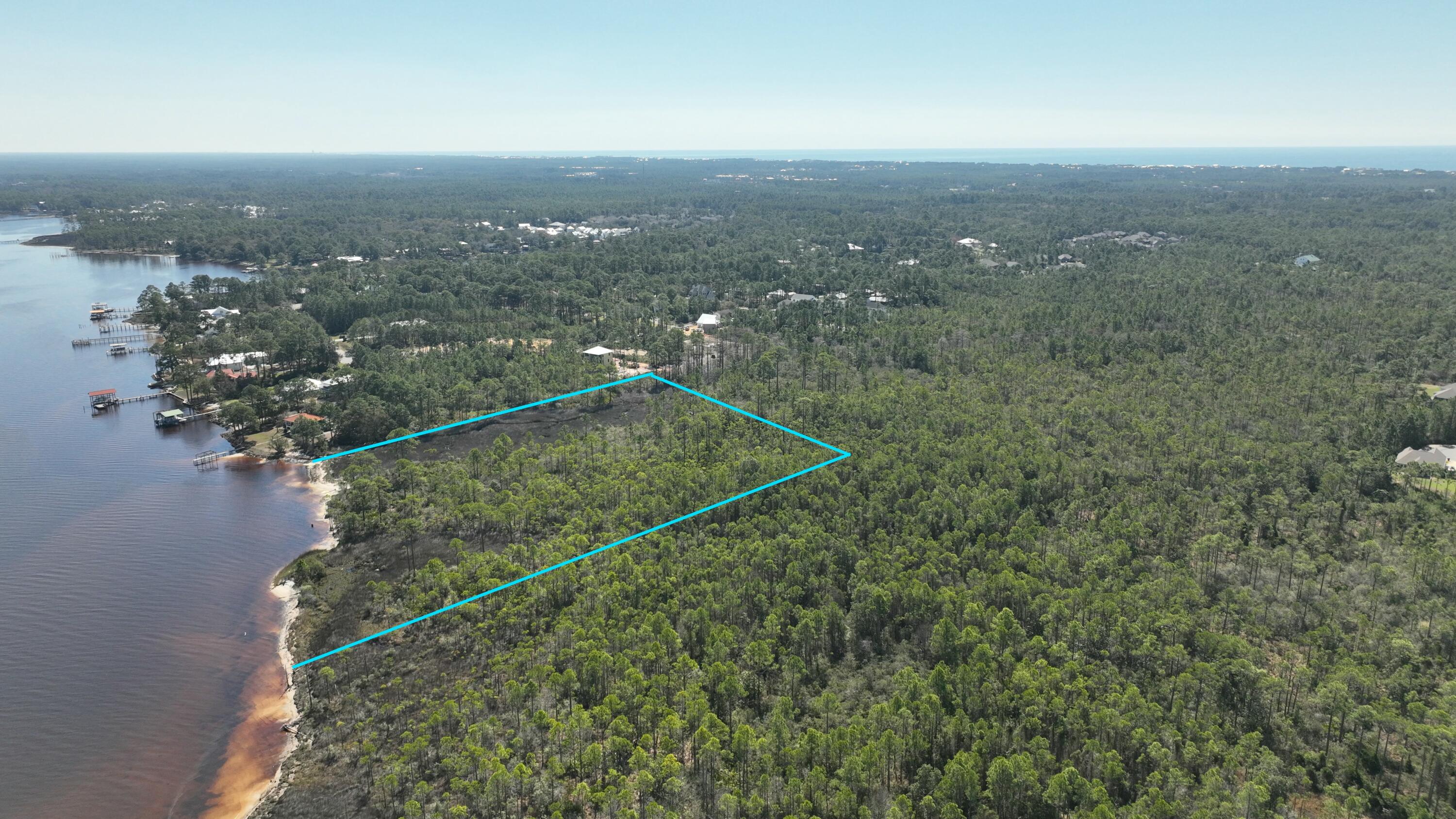 This exceptional Bayfront lot in Santa Rosa Beach, FL, offers one of the largest Bay fronts available in the cities market. With easy water access, it's ideal for boating and waterfront living. The property is perfectly positioned near the area's famous beaches, providing a prime location for beach lovers. With ample space, there's plenty of room to build multiple homes, making it a rare and highly desirable investment opportunity in this sought-after coastal community. Water utilities are conveniently located nearby on Don Bishop Road, making development easy and efficient. The property also features a beautiful creek along its side, offering a serene, natural setting with plenty of privacy. Most of the land behind and surrounding the property is state-owned, ensuring even more seclusion and tranquility. This unique combination of features provides an unmatched opportunity for a private, waterfront estate with minimal disruption from surrounding developments.

This property is ideally located close to some of the most beautiful cities on the Emerald Coast, including Destin, Inlet Beach, and Miramar Beach, offering easy access to vibrant dining, shopping, and entertainment options. The lot also features stunning, mature trees, adding character and charm to the landscape. These towering trees provide shade, privacy, and a natural beauty that enhances the property, making it the perfect setting for your dream waterfront home. Fall in love with this one of a kind property and come see it today.
