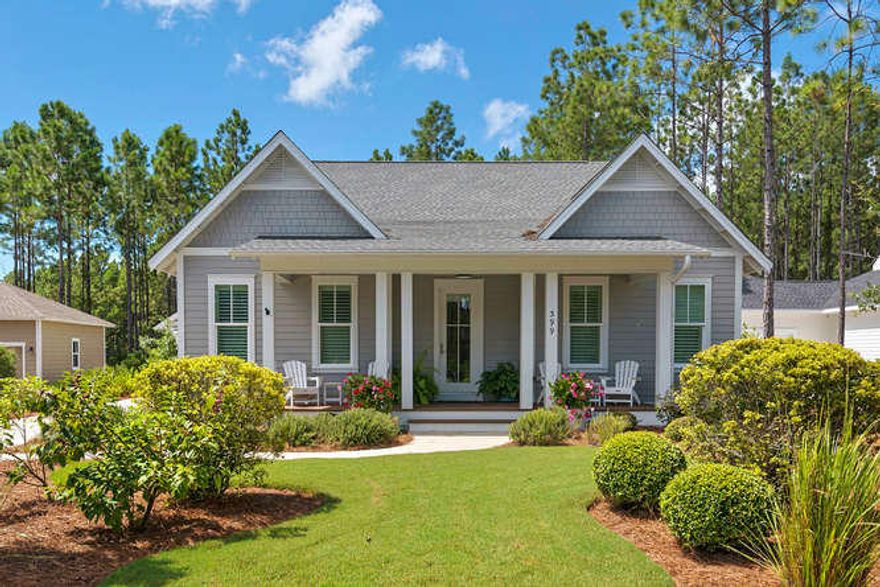 BREATHTAKING WATERSOUND ORIGINS OASIS with curb appeal galore! A welcoming rocking chair porch leads you onto gleaming hardwoods and a wealth of bright open spaces and fine finishes. Gourmet kitchen features breakfast bar, granite counters, stainless steel appliances with view to dining and great room with fireplace. Serene owners suite with spa bath, nicely appointed secondary bedrooms and baths, one has a built-in desk and sitting area and another near foyer offers french doors perfect for parlor or home office. Incredible covered deck with stone fireplace and room for entertaining and relaxing. Custom tiered POOL with spa, spacious premium decking. Detailed privacy fence overlooks wooded landscape. Detached 2 garage with great storage. MOVE-IN READY and a MUST SEE!