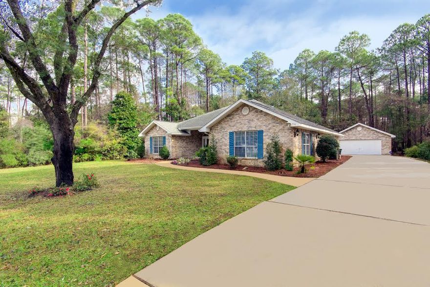 Beautiful 4 bedroom home with large bonus room (or large 5th bedroom), 2.5 bathrooms on large wooded lot. Detached 2 car garage with plenty of room for storage. Immaculately clean and ready for its new owner. All the rooms are very generous in size, both a great room and a family room, playroom or office, formal dining room, an open kitchen with a breakfast nook and pantry, laundry, etc. Constructed on one of the most desirable Bay view home-sites in Driftwood Estates, this carefully landscaped home enjoys the privacy and beauty of an abundance of mature trees and natural vegetation in a conservation area. Minutes from South Walton Fire Department, Sacred Heart Hospital, Grand Boulevard shopping and restaurants, and the beautiful beaches