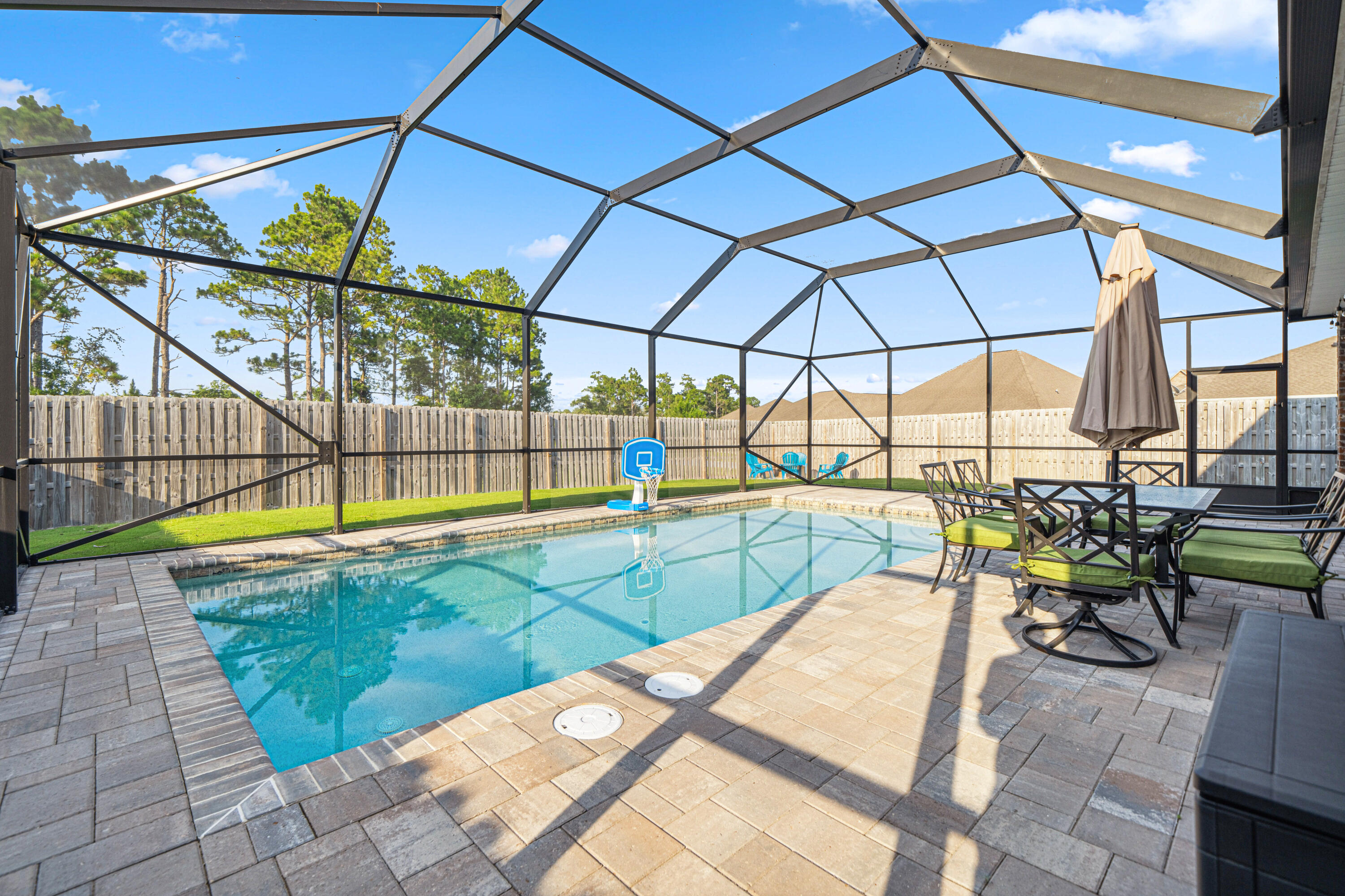 Azalea plan with brand-new heated saltwater gunite pool--fully enclosed with a screened enclosure! Surrounded by elegant pavers, the pool area sets the scene for relaxing weekends and evenings spent swimming under the stars. Beyond the pool, the huge fenced backyard includes a fire pit area for gathering with family and friends. Whether you're roasting marshmallows or sipping wine by the fire, this space is built for making memories. Peach Creek has no short term rentals and is located minutes from schools, beaches, restaurants, shopping, and is a short drive to iconic Seaside and Rosemary Beach. This spacious home has 4 bedrooms, 3.5 baths, and a large upstairs bonus room that makes the perfect second living area, movie room, or playroom. The first-floor master suite overlooks the pool and has a large walk-in closet and an en suite with double vanity, walk-in shower, and linen closet. The first floor also has an under-stairs storage closet and half bath for guests. Upstairs there are three generously-sized bedrooms with walk-in closets, a large bonus room, and a dedicated laundry room. Two of the bedrooms share a Jack and Jill bathroom with double vanity and shower/tub combo. The additional guest bedroom has a full bathroom just off the hallway. Additional features include irrigation system and large two-car garage. Schedule a showing today!