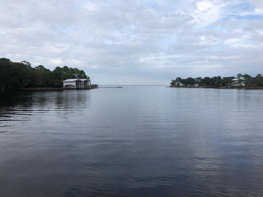 Own over 1/2 acre on Mack Bayou with no HOA and good water! This lot retains some large, natural trees and faces South giving you some relief with sea breezes in the summer and blocking the cold, stiff breeze in the winter! Nearly all of the homes leading to this lot are new, and this is a dead end street with very little traffic! Now is a great time to buy this waterfront gem and build your dream home on a quiet street that is close to both the shopping at Grande Boulevard and the 30A beaches and culture!