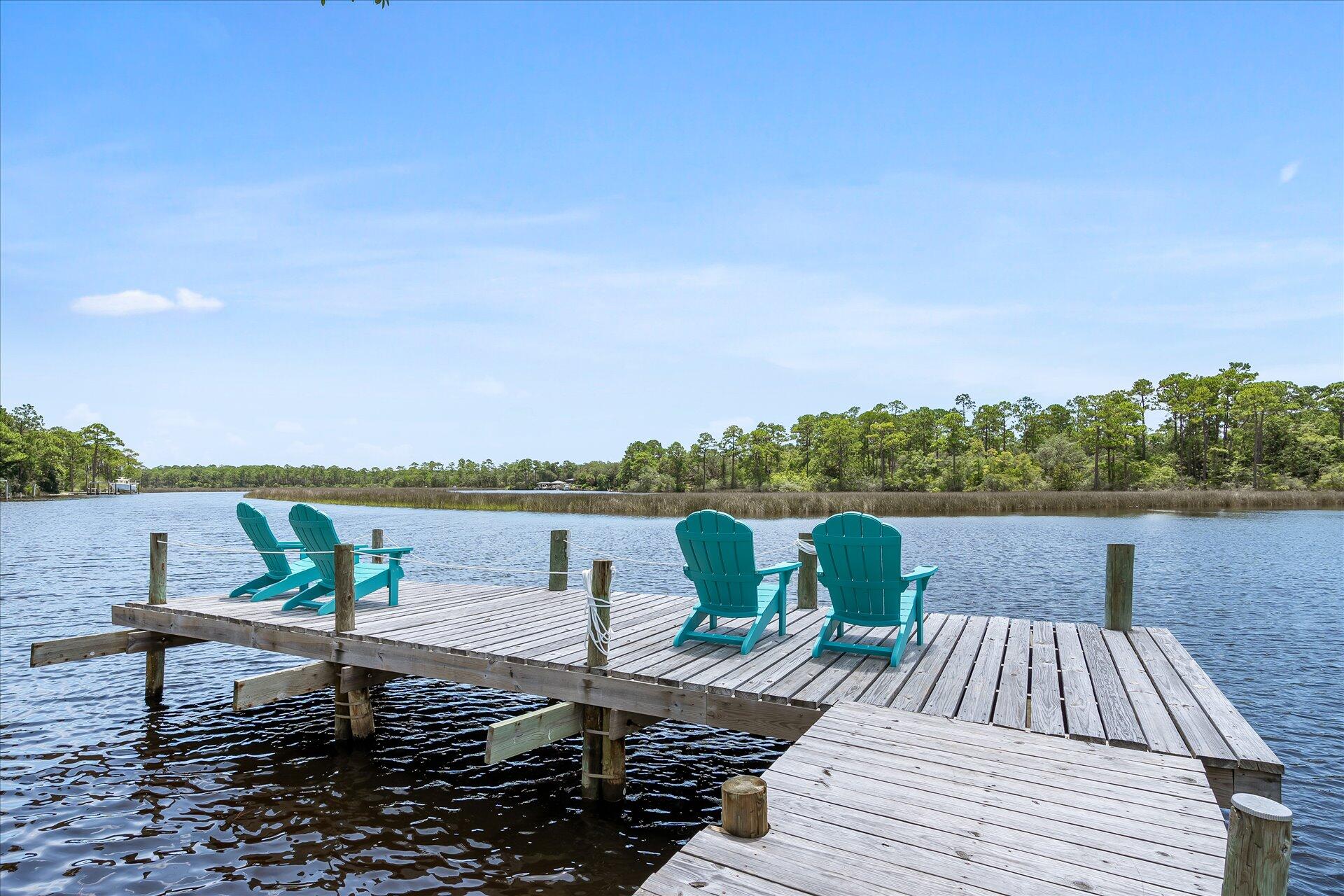 Vacation every day! Creole cottage with 2450 square feet of living space. Absolutely gorgeous bayou views from all the main rooms and 100ft directly on Bayou Grande. Deep water access on protected no wake zone. Moor your boat at the dock for quick access to Pensacola Bay. Kayak with the dolphins. Watch the Blue Angels up close and personal - your own personal air show! Off Grade home on concrete pillars with a large enclosed storage area under the house for all of your boating and fishing gear. Paid off Solar panels mean the average electric bill is $20 - $30. 3 Bedroom 2 Bath has been updated with newer flooring, custom bathroom vanities, walk in showers in both bathrooms. Renovated kitchen features high quality stainless appliances, glassed cabinets, recessed lighting, granite counters & an oversized island. Spacious living room in the heart of the home. The perfect relaxing spot for movie night. Dine in the breath taking sunroom where the views, both day and night, are spectacular! Extra large primary suite with french doors opening to the private sunroom area. Fully fenced yard. Make sure to sit a while on the dock so you can see the dolphins swim by!
