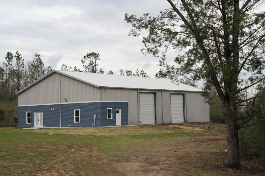 Such a rare and unique property on 15 plus acres. Completely remodeled living space integrated into a warehouse or workshop building that lets you get creative on its use. If you have been looking for live work create space - this is the place! The warehouse/workshop which is an over 3200 SF area consists of two 14 foot high rollup doors, a half bathroom, and a 17x51 foot storage space over the living space. The living quarters consists of 1 amply sized bedroom plus closet storage, a fabulously updated bathroom, an open kitchen/dining combo and a living room that could double as an office. Brand new Windows, Flooring, A/C, updated bathroom, kitchen and new appliances. Situated on 15 acres of land, you will be amazed with the possibilities!