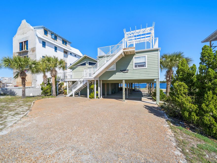 An exceptional opportunity awaits to transform this charming beach cottage into your dream waterfront retreat on the picturesque shores of Eastern Lake. Offered in 'as-is' condition, this beloved home has been the backdrop for years of cherished memories and is currently a successful short-term rental with Benchmark Rentals Company. Set along one of 30A's rare coastal dune lakes, the property provides a seamless blend of lakefront serenity and effortless beach access, offering the best of both worlds. The sellers thoughtfully expanded the home, enclosing part of the downstairs to create an additional bedroom, a full bathroom, an owner's closet and interior storage space. Upstairs, the primary suite takes full advantage of its breathtaking waterfront setting, with a private bath and expansive views of Eastern Lake. The open-concept living area is bathed in natural light, with floor-to-ceiling windows framing the lake and leading to an expansive back deck and private boat dock. A cozy fireplace with built-in cabinetry enhances the space, while the adjacent screened porch captures refreshing gulf breezes and scenic views. Positioned just steps from two beach access points, this home offers easy strolls to the gulf's sugar-white sands. San Roy Road is a highly desirable enclave, where original beach cottages and stunning new construction homes coexist, adding to the charm and character of this sought-after location. Whether you envision a complete remodel or a thoughtful refresh, this property presents a rare chance to create a coastal sanctuary in a setting that offers both tranquility and adventure. Eastern Lake is a paradise for water enthusiasts, where paddle boarding, kayaking, and breathtaking sunsets become part of daily life.