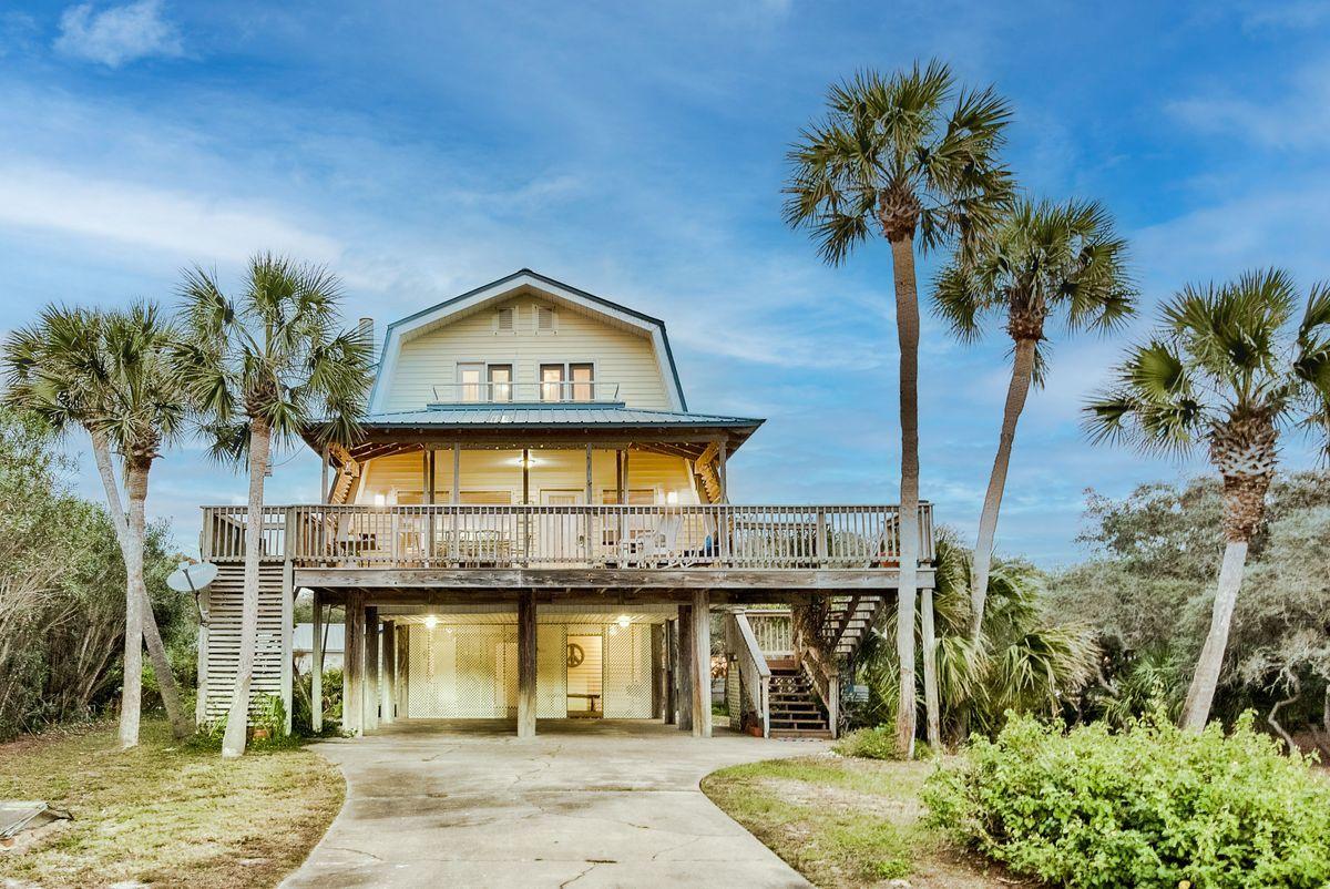 This highly coveted second-tier location in Old Blue Mountain Beach nestles a charming vintage beach cottage boasting heart pine floors and a cozy fireplace. A generous quarter acre homesite offers future build-out potential as well as up to Walton County's height restriction of 50'. Some renovation on bathrooms has been completed. Great Gulf views across road. Beach access is three lots over to either side. Old Blue Mountain neighborhood owners have BEACH USE rights, not just beach access, a rare amenity in neighborhoods along 30A! Also, there is a mechanical lift from the carport to the second floor! Stroll to restaurants, cafes, bakery & grocery or jump on your bike and hit the bike path.