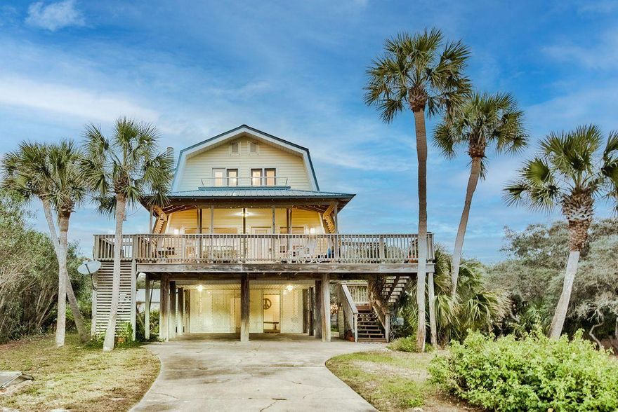 This highly coveted second-tier location in Old Blue Mountain Beach nestles a charming vintage beach cottage boasting heart pine floors and a cozy fireplace.  A generous quarter acre homesite offers future build-out potential as well as up to Walton County's height restriction of 50'.  Some renovation on bathrooms has been completed.  Great Gulf views across road.  Beach access is three lots over to either side. Old Blue Mountain neighborhood owners have BEACH USE rights, not just beach access, a rare amenity in neighborhoods along 30A!   Also, there is a mechanical lift from the carport to the second floor!  Stroll to restaurants, cafes, bakery & grocery or jump on your bike and hit the bike path.