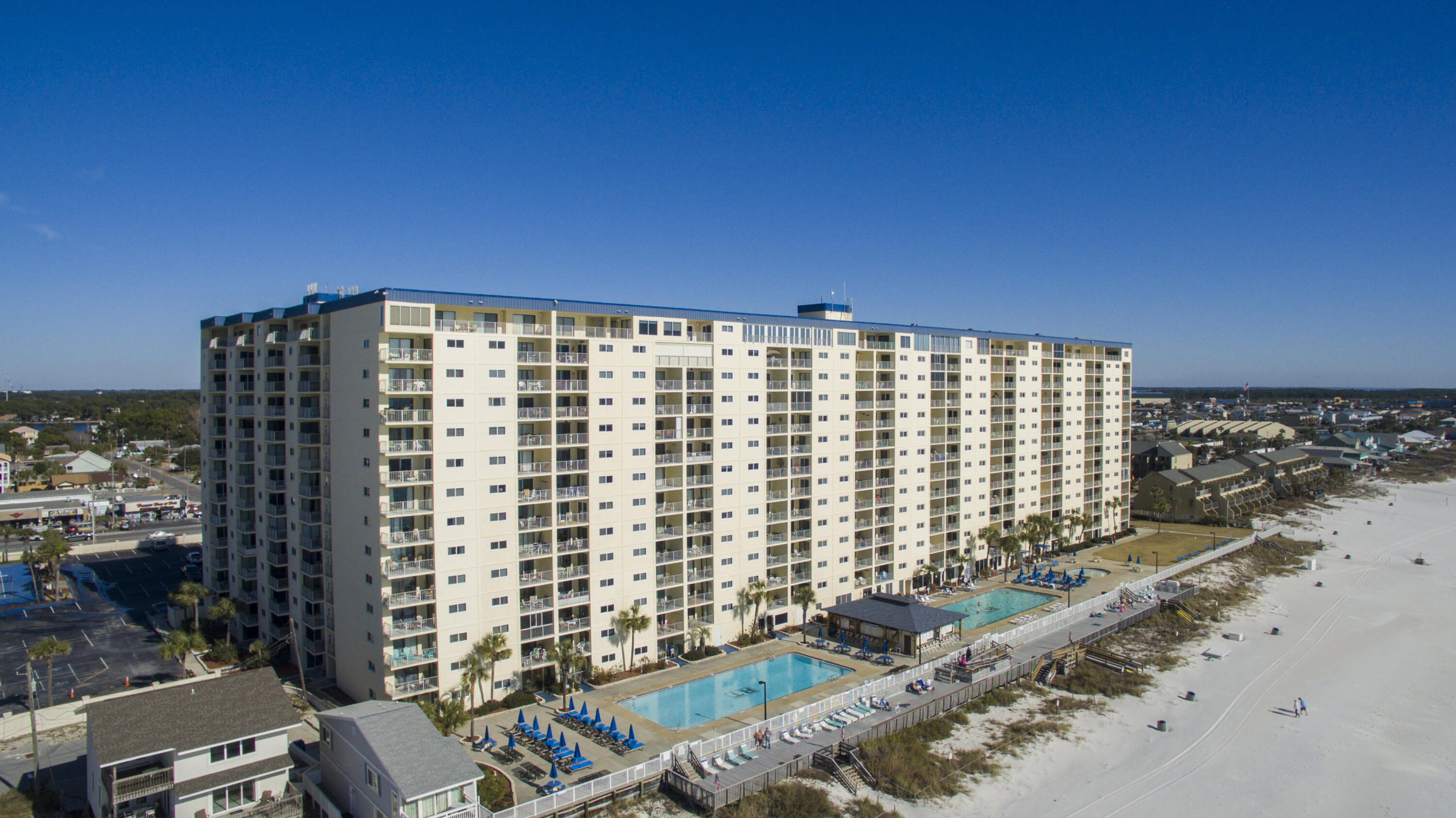 Welcome to Regency Towers Condo unit 611, a captivating gem in Panama City Beach.  This immaculate 2-bedroom, 2-bath unit is a turnkey vacation rental, perfect for investors and beach lovers alike. Professionally renovated, this condo exudes coastal charm including new sliding glass doors in the living room and master bedroom, granite countertops, LVP flooring, and both bathrooms. The coastal decor and beachy furnishings further enhance the beachside ambiance, providing a true retreat for vacationers. Situated on the coveted 6th floor, this unit offers stunning beachfront views from the living room and master bedroom. The gated security of Regency Towers ensures privacy and tranquility Amenities include two large pools, a tiki bar, hot tub, tennis courts, shuffleboard, and exercise room