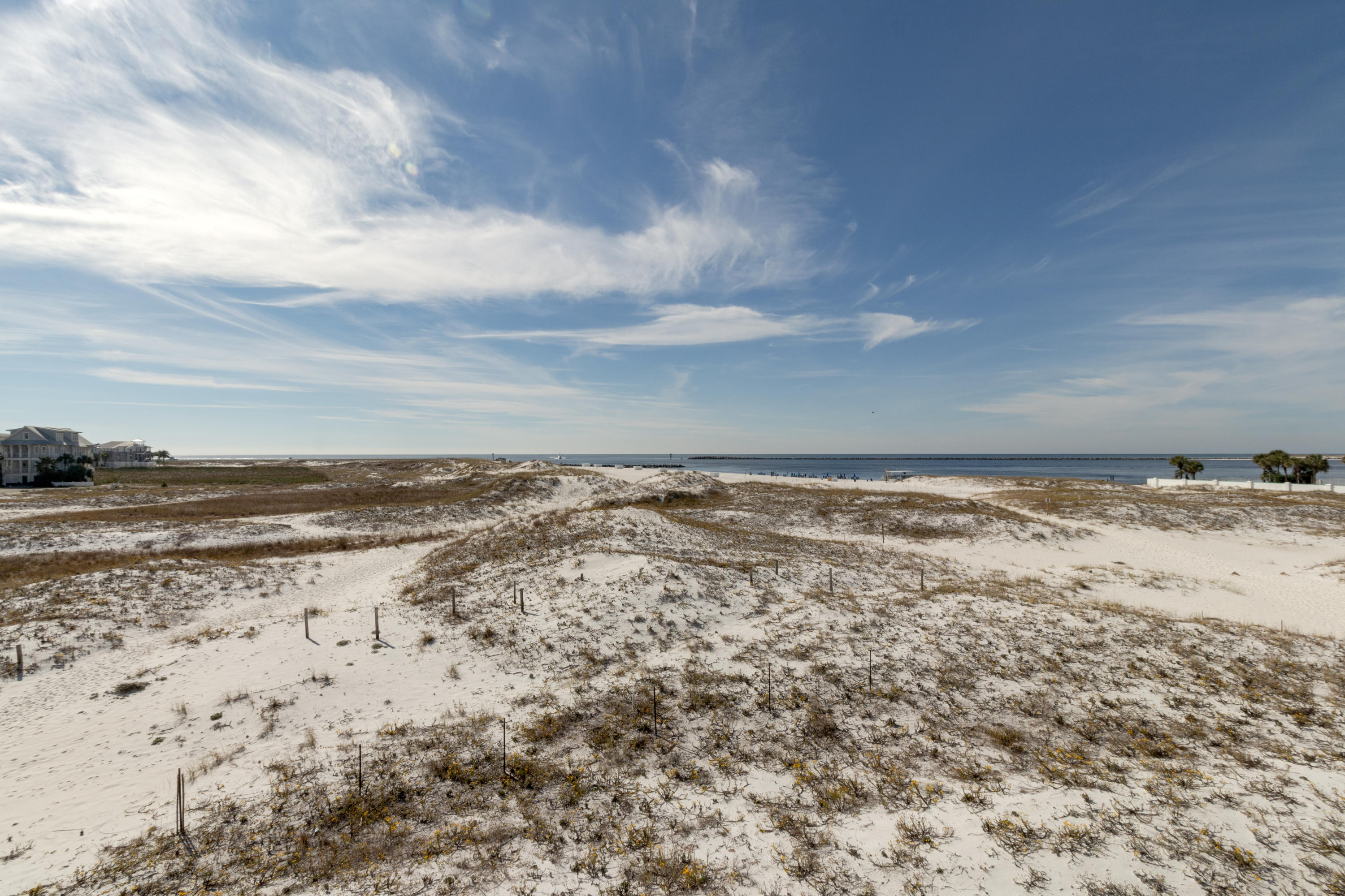 Unobstructed Amazing Views of the Jetties and East Pass from this 2BR/2.5BA 1,648SF Town-home Nestled Amongst Sugar White Dunes of Holiday Isle. Features Tile and Wood Floors, Granite Countertops, Jetted Tub, Outdoor Shower, Covered Parking & 2 Exterior Owner's Closets. Fully Furnished and Rental Ready!