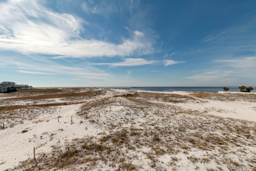 Unobstructed Amazing Views of the Jetties and East Pass from this 2BR/2.5BA 1,648SF Town-home Nestled Amongst Sugar White Dunes of Holiday Isle. Features Tile and Wood Floors, Granite Countertops, Jetted Tub, Outdoor Shower, Covered Parking & 2 Exterior Owner's Closets. Fully Furnished and Rental Ready!