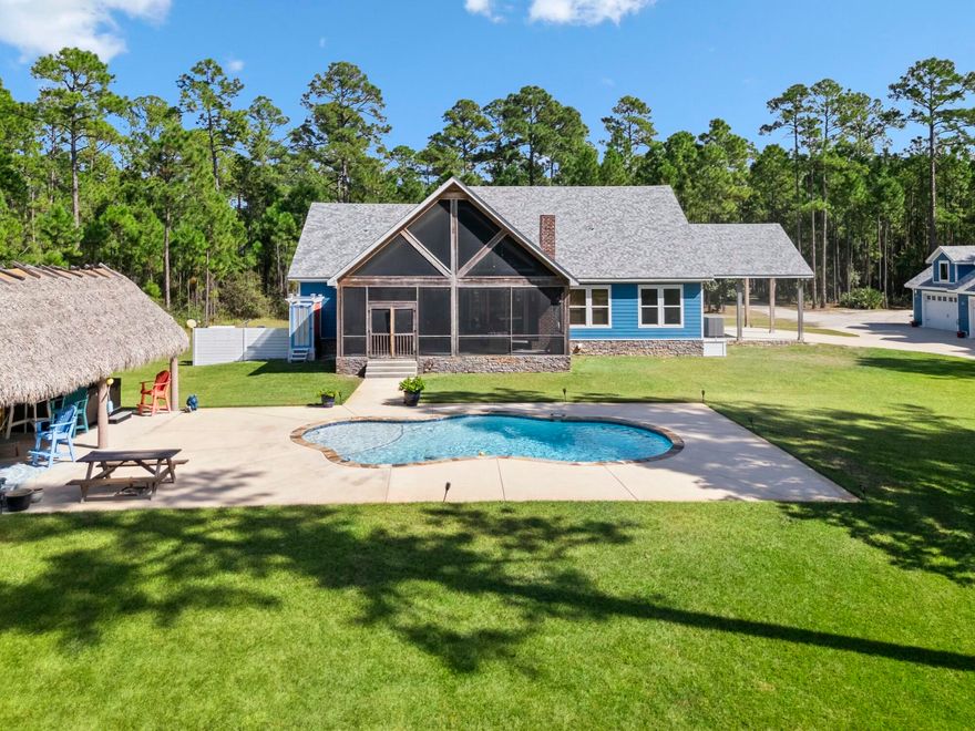 Discover the perfect blend of modern design and serene estate living in this meticulously constructed coastal farmhouse. Nestled on a lush 10 acres northwest of Co Hwy 393, this 4 bedroom, 3 bathroom residence is nothing short of amazing. This home is perfect for entertaining with an open concept design featuring a large gourmet kitchen with standalone island, a wine and coffee bar, ice maker, and oversized walk-in pantry. The living area showcases pine inlay vaulted ceilings and a stacked stone fireplace, with a dedicated office/flex space off to one side. The outdoor space is what truly sets this property apart. Attached to the back of the home is an expansive vaulted screened-in patio with a wood burning fireplace, seating area, and al fresco dining space. This home also features an outdoor oasis with a large in-ground pool, tiki-hut and bar, a hot tub, and a raised garden. 

In addition to the home itself, this property features a separate four-bay garage with a workshop, abundant storage, and onsite electric hookups for an RV. Additional amenities include a gated entrance, a mudroom with extra storage and dog washing station, and a whole house generator.

This expansive estate offers a rare combination of seclusion and convenience with abundant wildlife and lush foliage, all while being just two miles from Cessna Landing and minutes from shopping, dining, entertainment, and the sugar white sand beaches of 30A.

*Tractor not included
