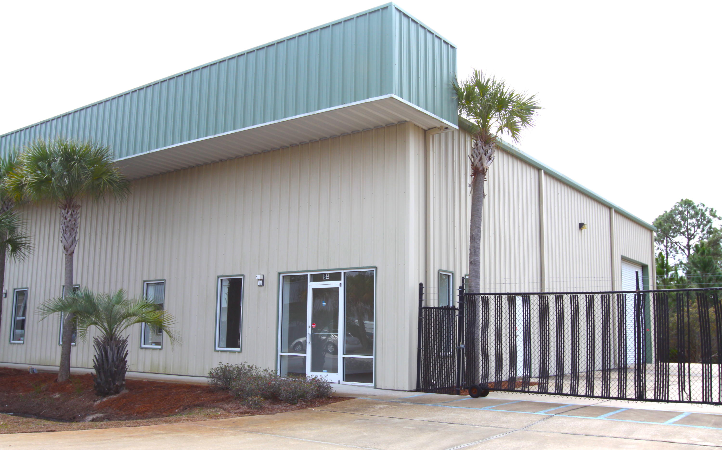 This 2400sf office warehouse is located between the west end of 30A and Sandestin. The 500sf +/-office portion of this unit is an open area with 10ft ceilings and a glass storefront. The 1900sf warehouse portion has two 14ft overhead doors with a covered loading area behind the building.