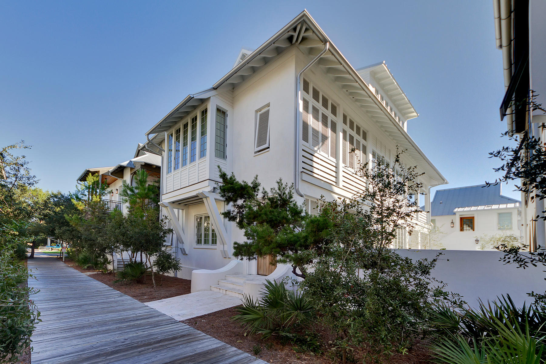 A MASTERPIECE OF DESIGN AND ARCHITECTURE BY Domin Bock Architects, this elegant Courtyard Style Home with Main House and Carriage House is fused with an eclectic arrangement of Tiles, white-washed Lathed Wood walls and white oak hardwood floors throughout. A spacious lot allows entry from the Boardwalk into the contiguous Courtyard featuring a heated Pool, outdoor Kitchen and outdoor Fireplace. In the Main House, The Urban concept of ''living over the street'' promotes a 2nd Floor Living area which opens to the Dining/Kitchen as well as flows thru French doors to a wrap-a-round Balcony. Level 2 also host 1 of 2 Master Suites. Level 1 entertains a spacious Lounge complete with a folding Nana door to provide seamless exposure to the Courtyard, the 2nd Master Suite and a Guest Suite.