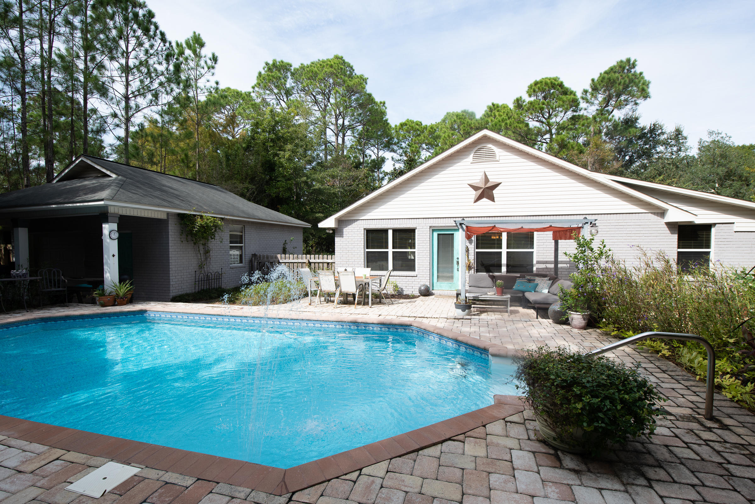 TRANQUILITY AT ITS FINEST. This beautiful Gulf Breeze 3 bed 2 bath home is in perfect move in ready condition. This home is a beautiful oasis that you are sure to fall in love with at first sight. Newly painted brick and a well manicured yard make for the best curb appeal. The entrance of the home is so warm and welcoming you will feel right at home from the start. Here you will find an open floor plan and Beautiful Travertine floors flowing throughout. The Kitchen boasts new stainless steel appliances, granite countertops, and custom cabinets. The chef of the family will love overlooking the dining and family room while cooking up a feast! The oversized walk in pantry is great for stocking up on groceries and supplies. Here you have high ceilings and a beautiful detailed orange peel on th